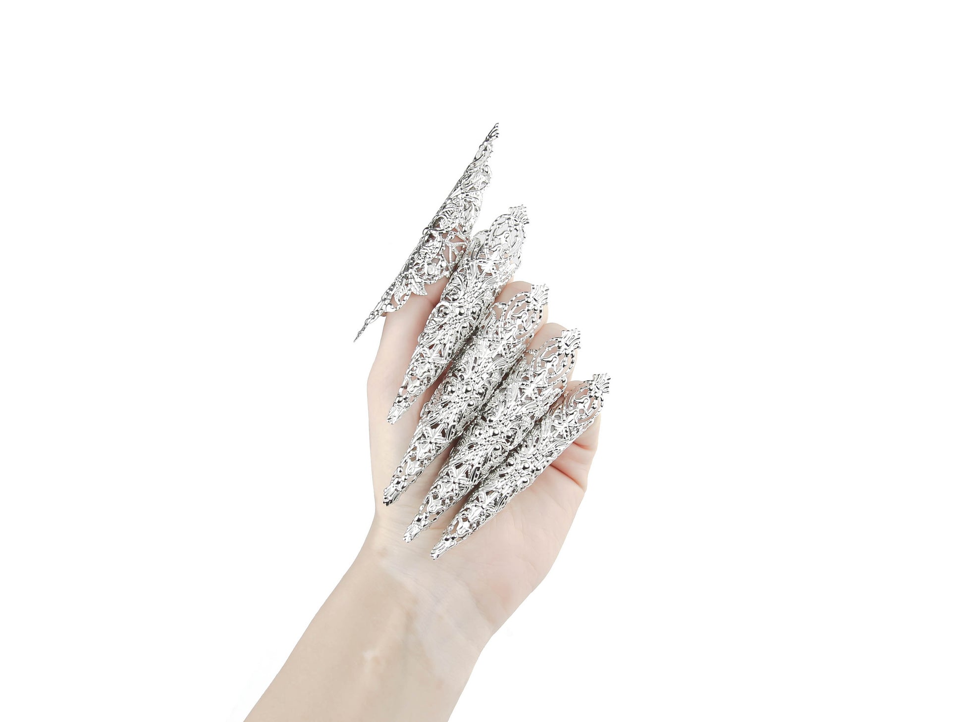 A hand models a full set of Myril Jewels' extra-long nail claws, exuding neo-gothic elegance. Designed for lovers of dark, avant-garde fashion, these claws are perfect for Halloween, punk looks, and witchcore enthusiasts. They make a bold statement for everyday wear, rave parties, and festivals, and are an unforgettable gift for the goth girlfriend.