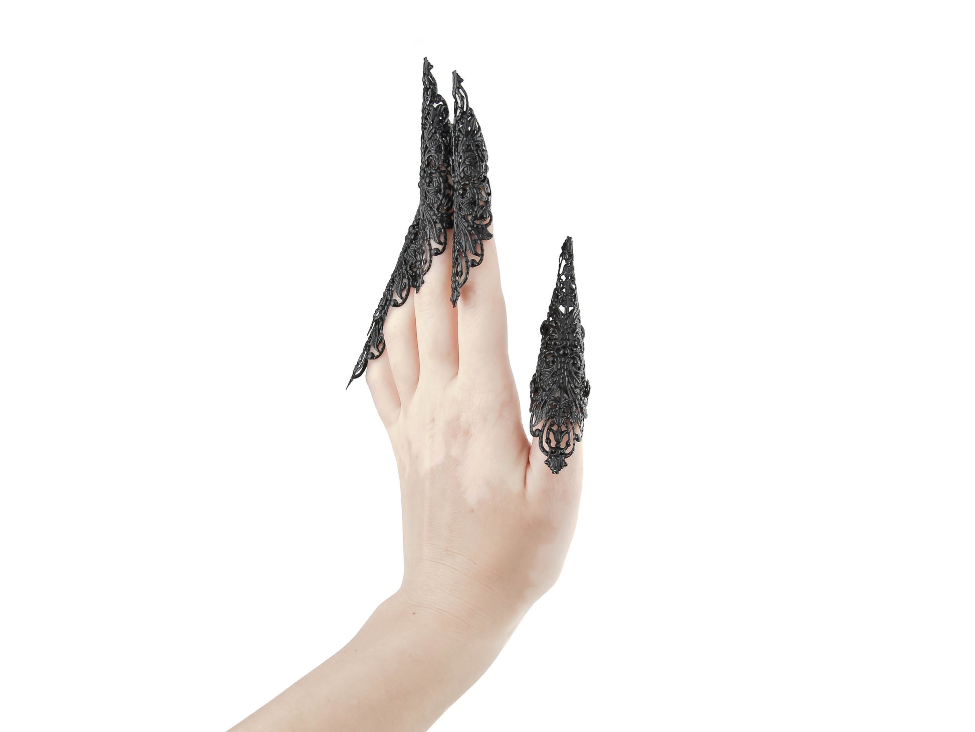 Captivating full hand set of Myril Jewels' extra long black nail claw rings showcased on a delicate hand. These neo-gothic claws are perfect for a dramatic goth-chic look, making a bold statement for Halloween, enhancing a rave party outfit, or as a memorable gift for the goth girlfriend with a love for dark avant-garde fashion.