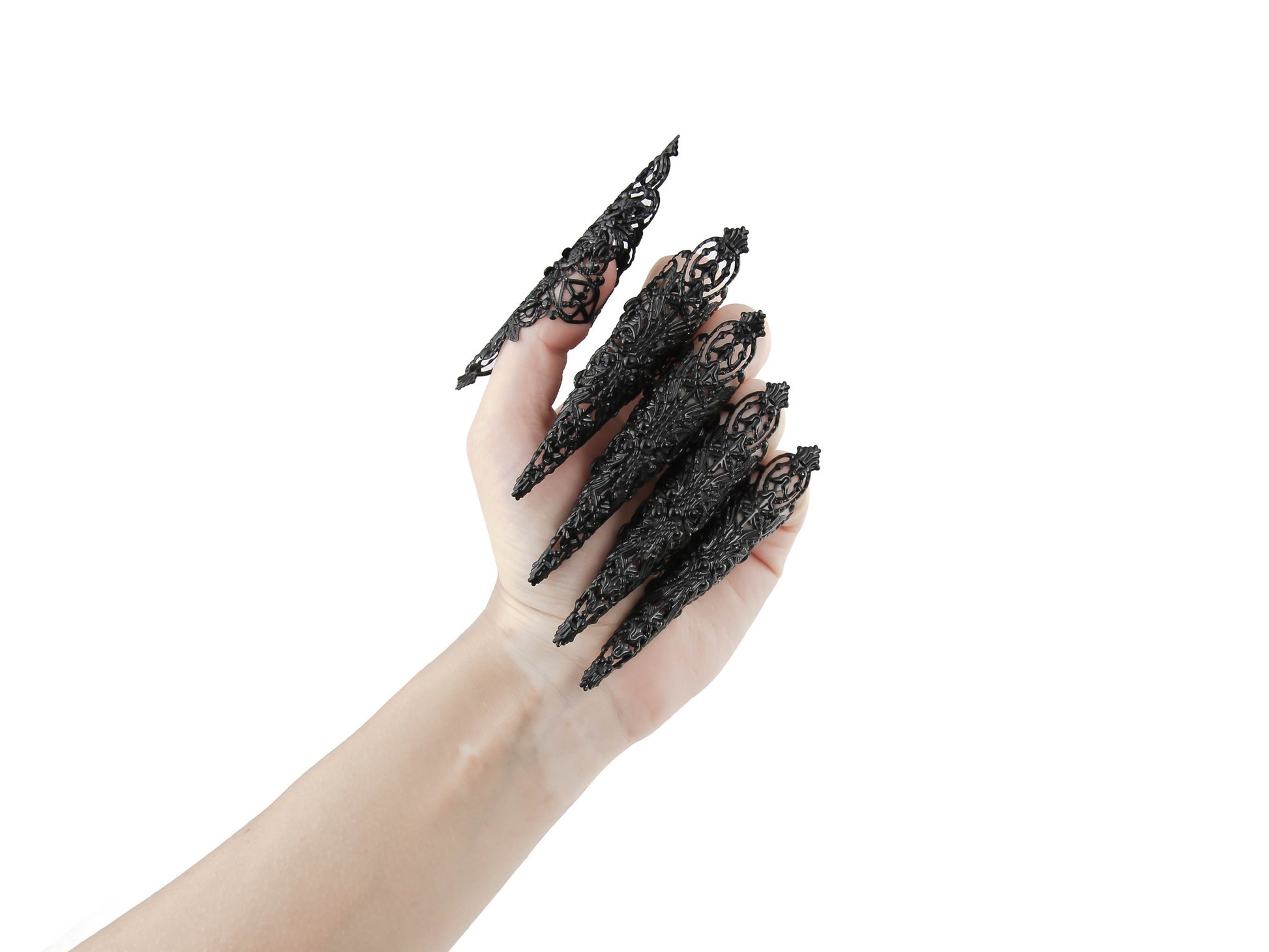 Captivating full hand set of Myril Jewels' extra long black nail claw rings showcased on a delicate hand. These neo-gothic claws are perfect for a dramatic goth-chic look, making a bold statement for Halloween, enhancing a rave party outfit, or as a memorable gift for the goth girlfriend with a love for dark avant-garde fashion.