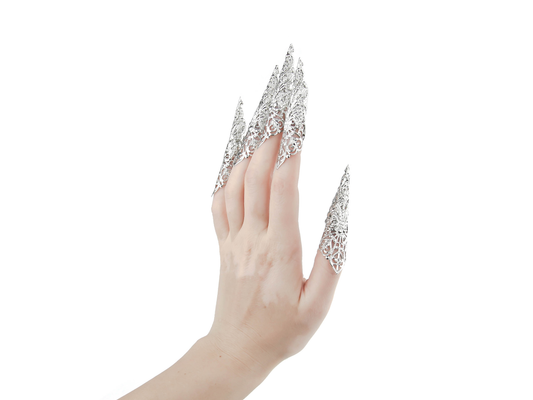 A hand models a full set of Myril Jewels' extra-long nail claws, exuding neo-gothic elegance. Designed for lovers of dark, avant-garde fashion, these claws are perfect for Halloween, punk looks, and witchcore enthusiasts. They make a bold statement for everyday wear, rave parties, and festivals, and are an unforgettable gift for the goth girlfriend.