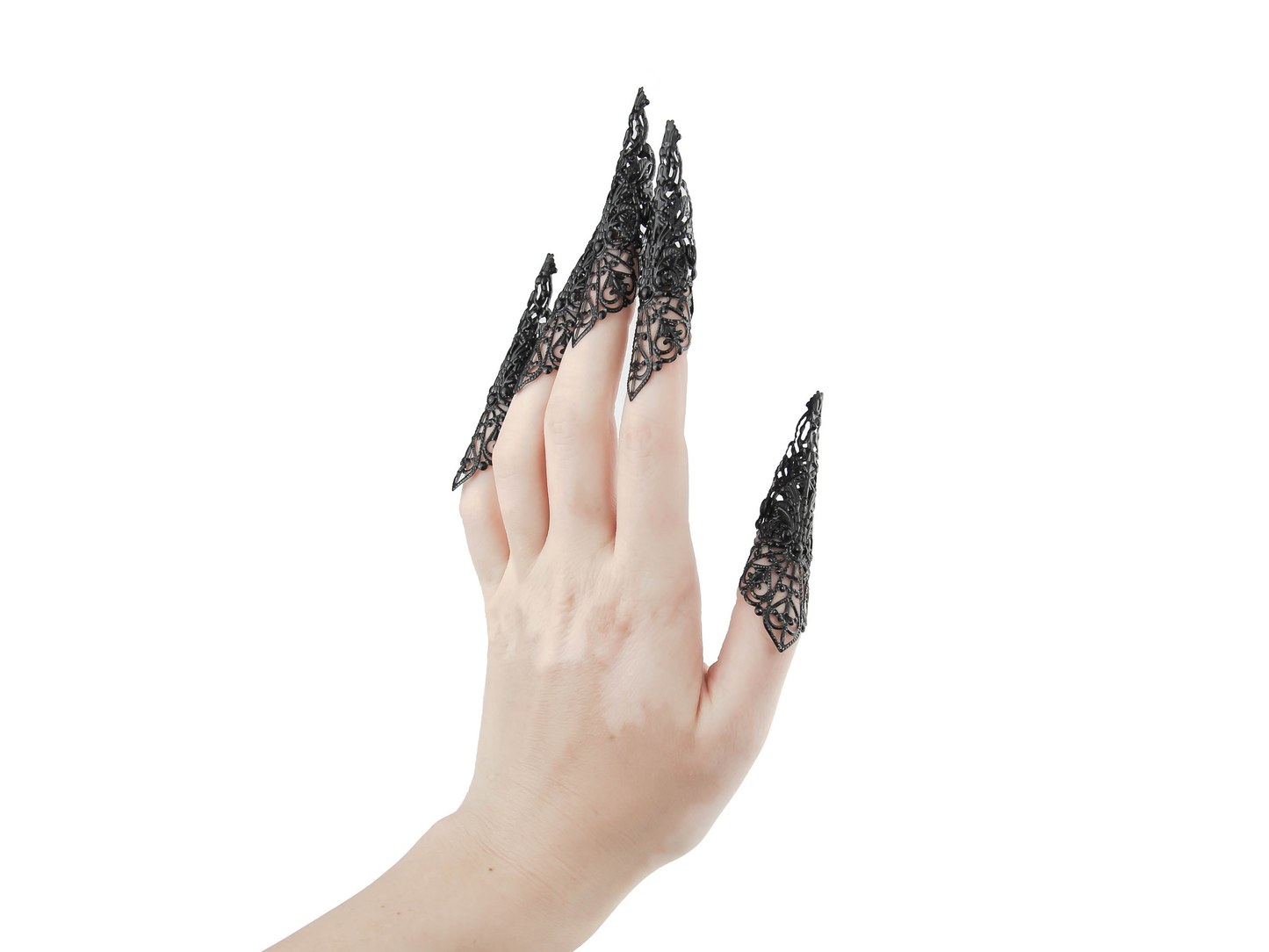 A full hand set of extra-long black nail claws by Myril Jewels showcases a bold neo-goth design, ideal for anyone with a love for dark, statement jewelry. Perfect for Halloween or as a standout accessory at a rave party, these claws encapsulate gothic-chic and witchcore styles, making them a unique gift for the goth girlfriend or for dramatic festival wear.