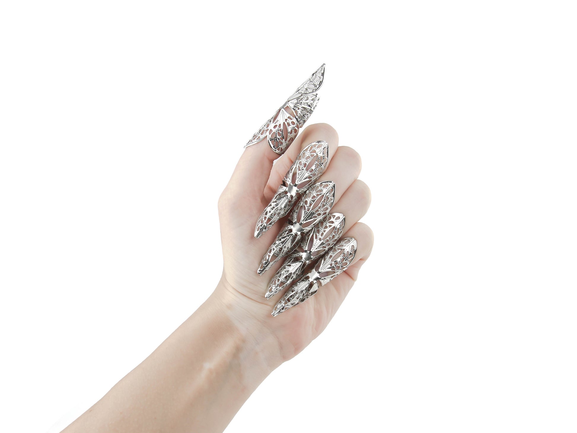 An elegant hand showcases Myril Jewels' long nail claws, reflecting a neo-gothic charm perfect for Halloween, witchcore, or everyday alternative wear. These bold, silver claws capture the essence of dark avant-garde fashion, ideal for those seeking gothic-chic, minimal goth, or standout festival jewelry. A daring choice for a goth girlfriend or as a unique, punk-inspired gift.