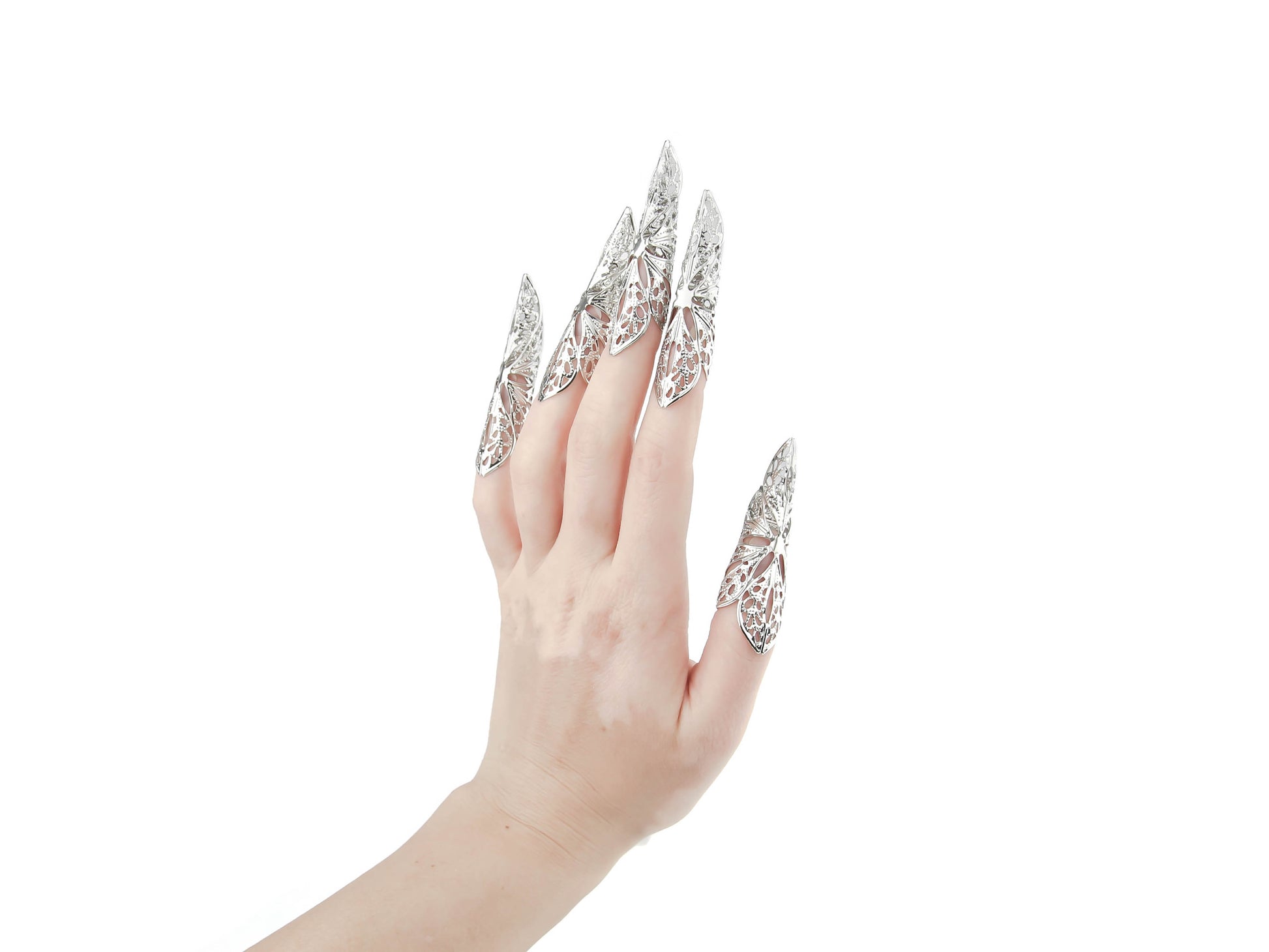 An elegant hand showcases Myril Jewels' long nail claws, reflecting a neo-gothic charm perfect for Halloween, witchcore, or everyday alternative wear. These bold, silver claws capture the essence of dark avant-garde fashion, ideal for those seeking gothic-chic, minimal goth, or standout festival jewelry. A daring choice for a goth girlfriend or as a unique, punk-inspired gift.
