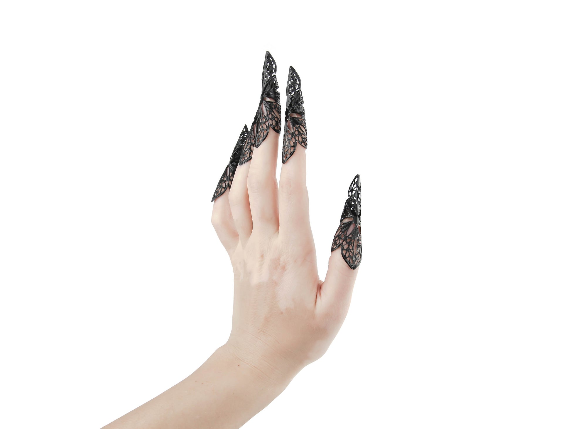 A hand is adorned with Myril Jewels' long black nail claws, a statement accessory for the neo-gothic aficionado. This striking piece fits perfectly within a Halloween or punk jewelry collection, also suitable for everyday wear by those with a love for gothic-chic or whimsigoth styles. The claws represent a bold choice for rave parties or festivals, and make an unforgettable goth girlfriend gift.