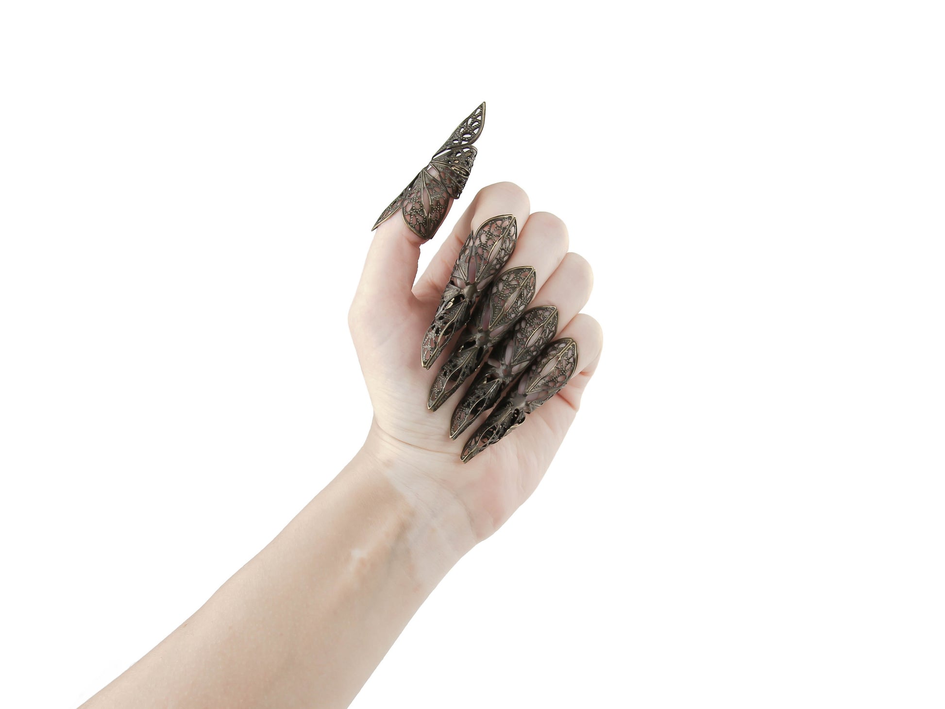 Delve into the world of Myril Jewels with these striking long bronze nail claws, embodying the essence of neo-gothic jewelry. These intricately designed pieces are perfect for Halloween, capturing the gothic-chic spirit and offering a bold touch to rave or festival outfits. They're a daring addition to any witchcore or minimal goth collection, making them an exceptional gift for the goth girlfriend who adores unique, statement jewelry.