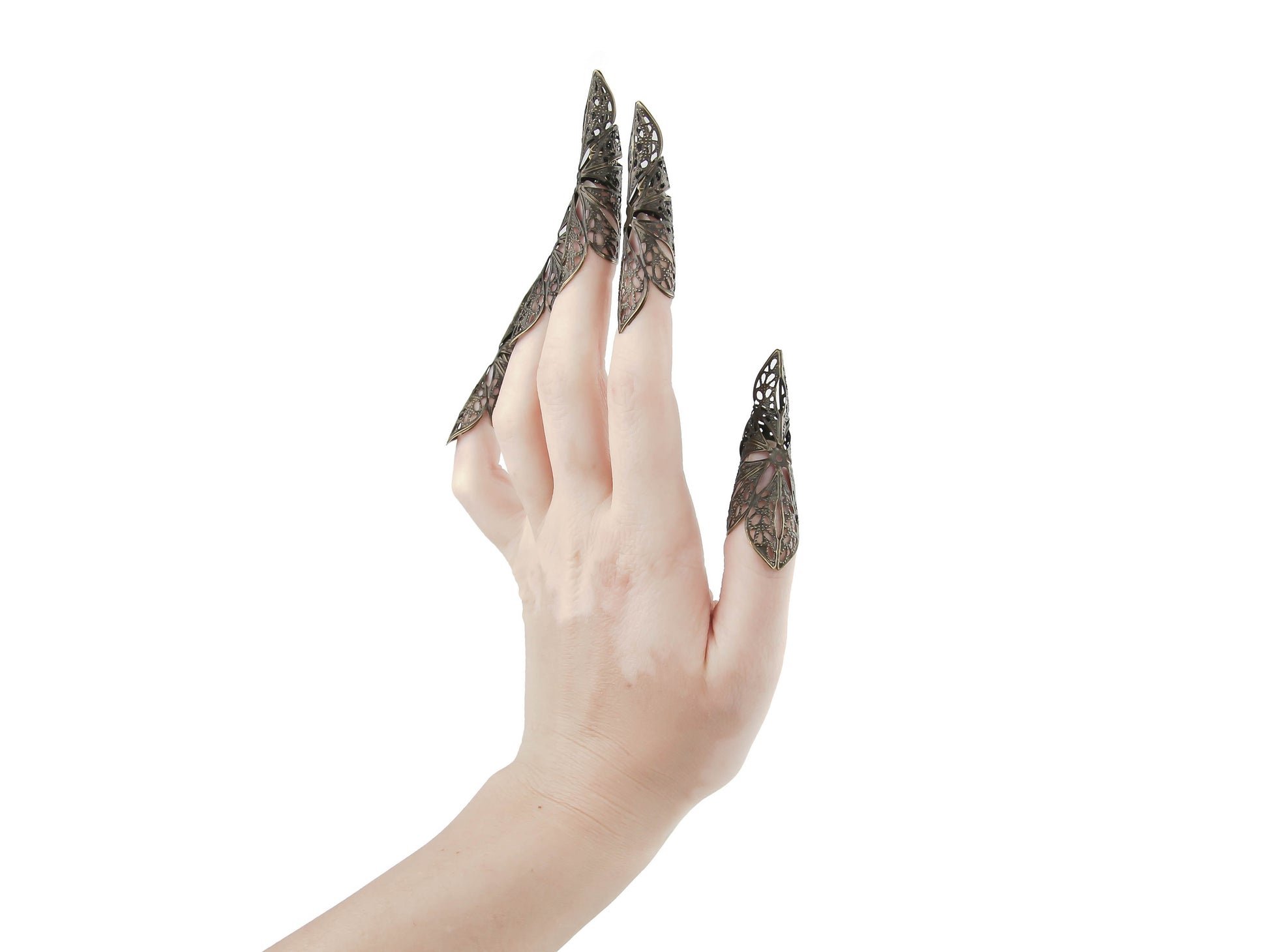 Delve into the world of Myril Jewels with these striking long bronze nail claws, embodying the essence of neo-gothic jewelry. These intricately designed pieces are perfect for Halloween, capturing the gothic-chic spirit and offering a bold touch to rave or festival outfits. They're a daring addition to any witchcore or minimal goth collection, making them an exceptional gift for the goth girlfriend who adores unique, statement jewelry.
