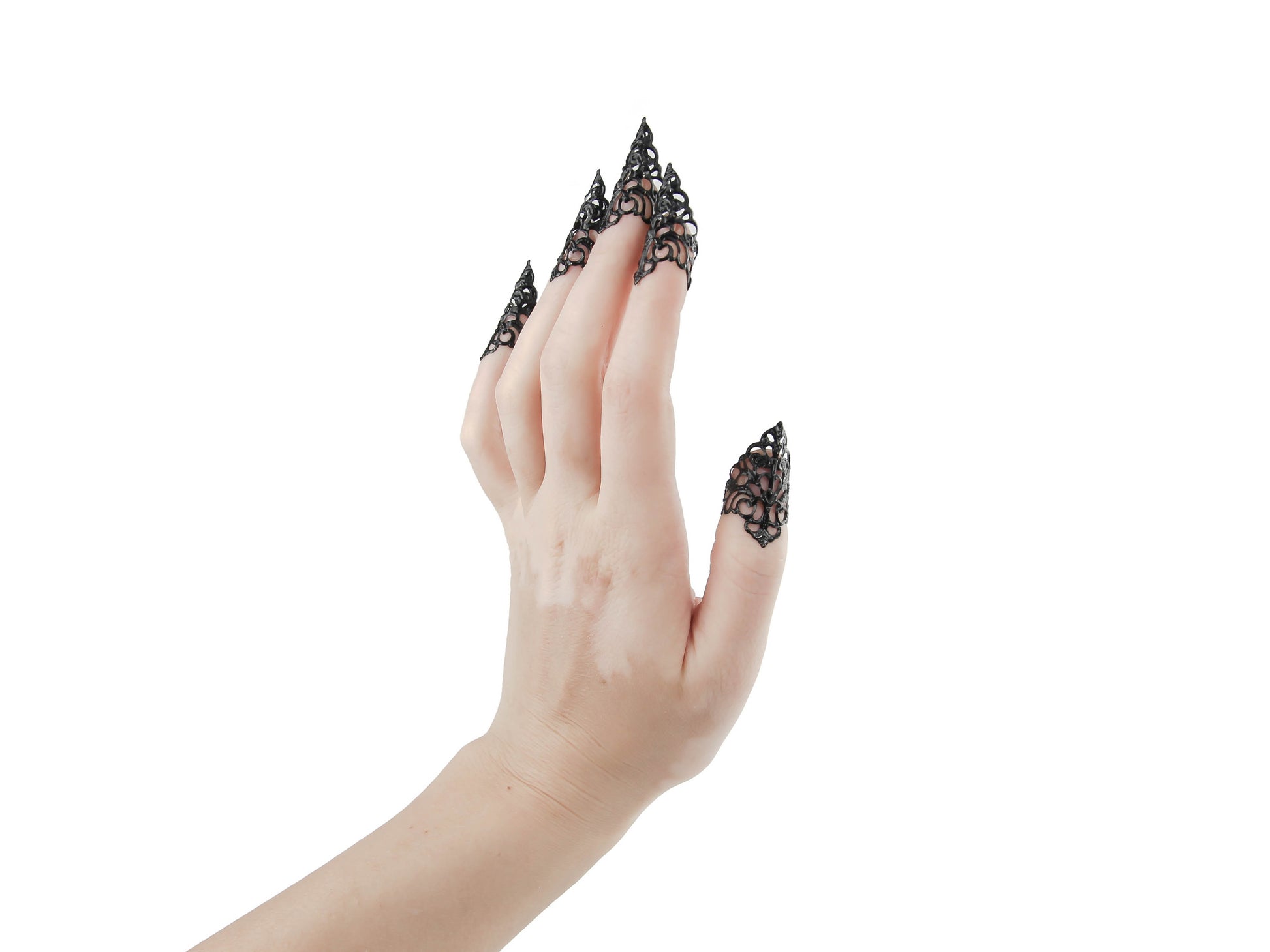 An image displays a hand adorned with Myril Jewels' gothic black nail jewels, exuding a neo-goth aesthetic with their claw-like design. These intricate black claws are perfect for Halloween, embodying punk and whimsigoth styles, and serve as bold jewelry for everyday wear or special events like raves and festivals. They are an ideal gift for the goth girlfriend who cherishes dark, alternative fashion.