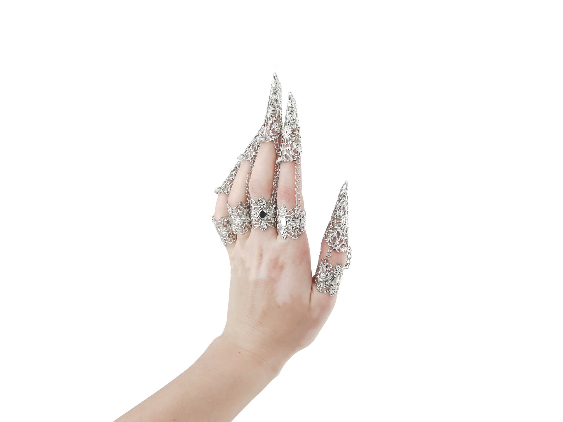 A hand models a full set of intricate claw rings from Myril Jewels, epitomizing the neo-goth aesthetic. Perfect for those drawn to dark, avant-garde fashion, these rings are a match for Halloween, punk styles, and gothic-chic looks. Suitable for witchcore, everyday wear, or as statement jewelry at raves and festivals, they make a bold gift for a goth girlfriend or anyone who adores unique, handcrafted accessories.
