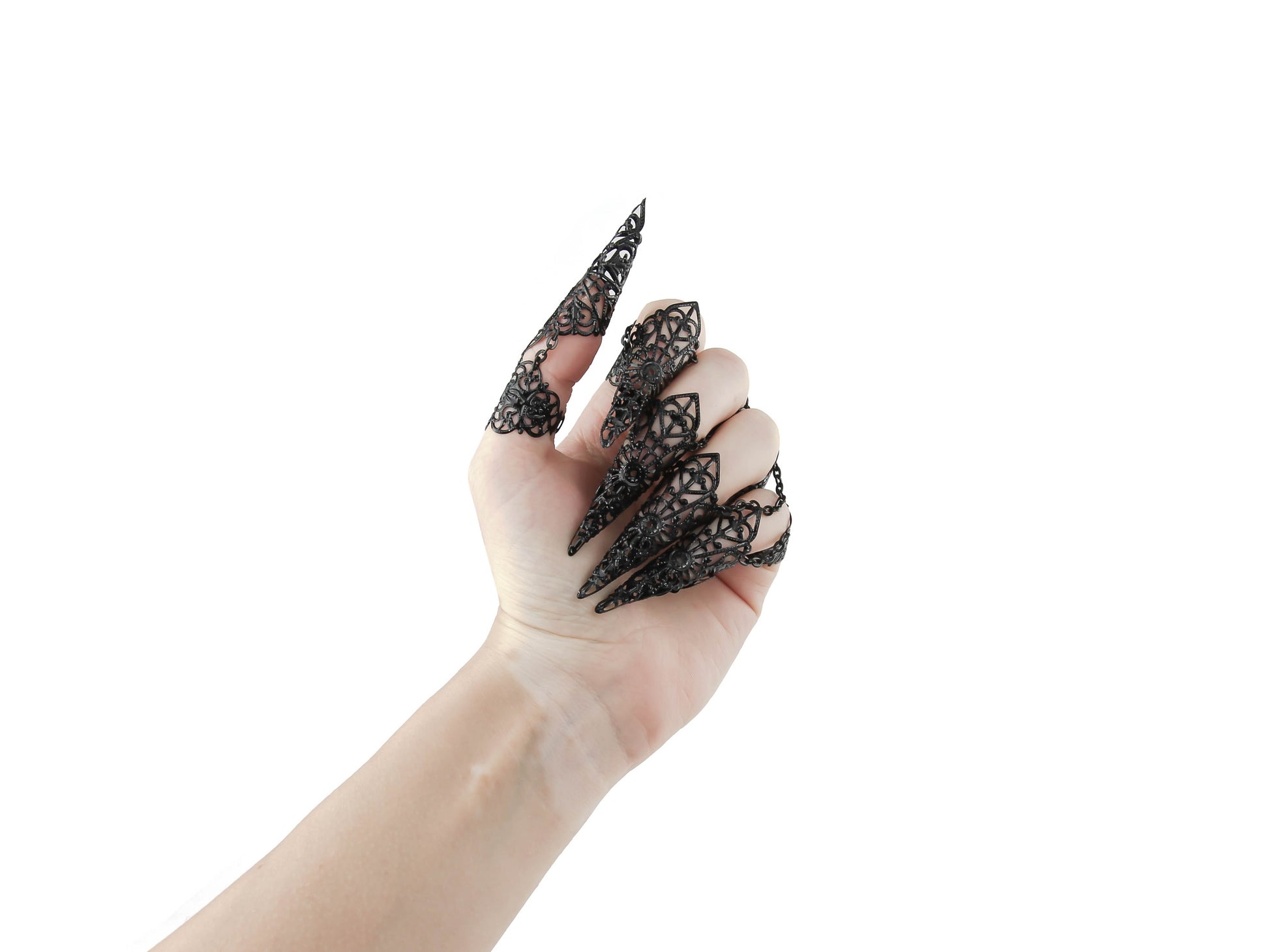 A hand is elegantly displayed, adorned with Myril Jewels' full set of ornate black rings with nail claws. These neo-goth pieces are the quintessence of gothic-chic, designed for those who favor dark, avant-garde jewelry, suitable for Halloween, festival wear, or as a striking everyday accessory