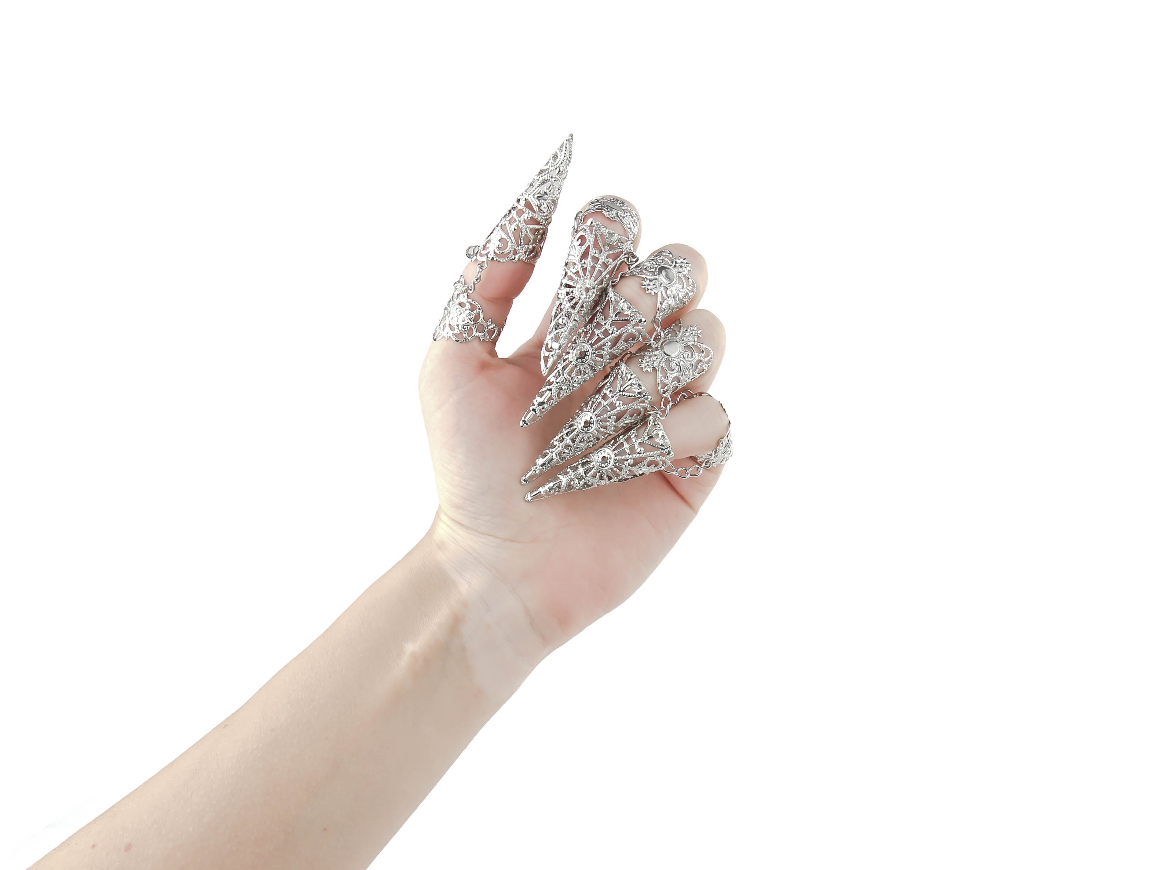 Adorn your hand with the Myril Jewels full hand set of midi rings, designed with an edgy claw-like silhouette for a neo-gothic statement. Perfect for gothic and alternative styles, these intricate silver rings are ideal for Halloween, adding a punk touch to your wardrobe. Their elaborate design captures the essence of gothic-chic jewellery, making them a staple for whimsigoth and witchcore aesthetics. Whether it's everyday wear or as a bold highlight for rave parties and festivals
