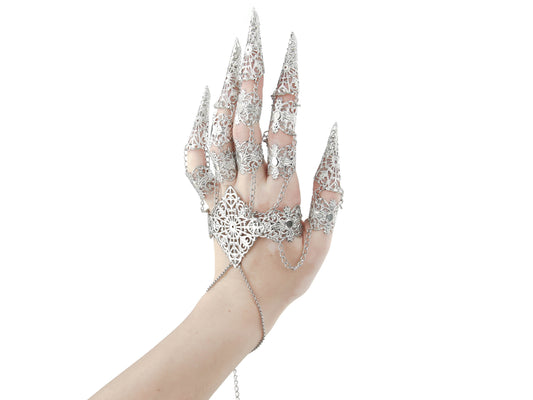 An elegant silver full hand metal glove with intricate claw rings creates a striking silhouette against a white background, a signature Myril Jewels design. This dark, avant-garde accessory embodies neo-gothic luxury, perfect for gothic, Witchcore, and punk fashion enthusiasts seeking bold jewelry statements