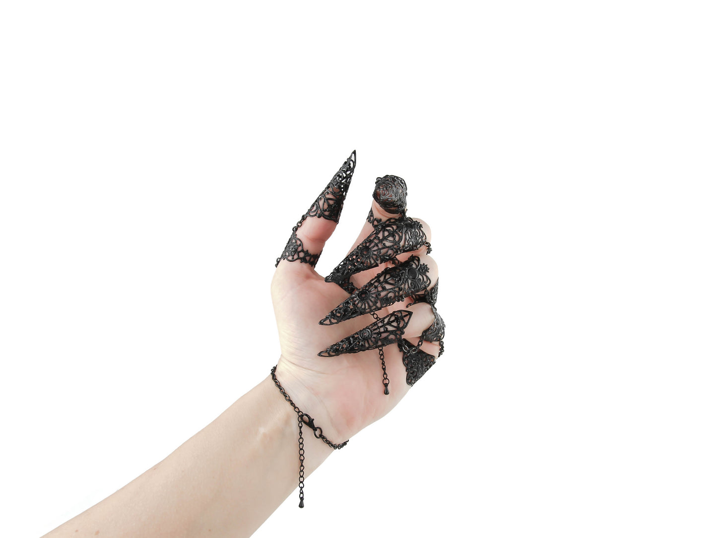 An ornate full hand black metal glove with claw rings from Myril Jewels encapsulates a neo-goth aesthetic. This exquisite piece is ideal for anyone seeking bold, dark-avantgarde jewelry, perfectly suited for gothic, punk, or Whimsigoth styles and makes an unforgettable goth girlfriend gift.