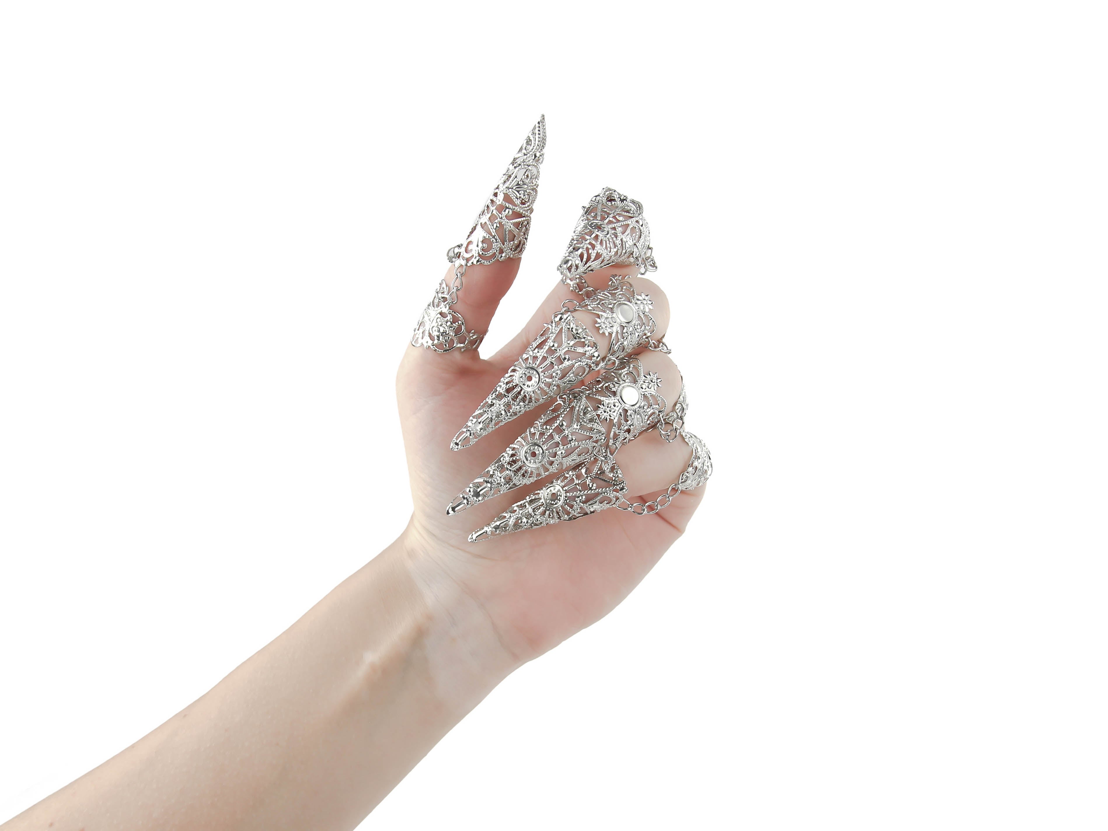 Myril Jewels presents a full hand set of armored claw rings, meticulously crafted with a filigree design that speaks to the heart of gothic opulence. This striking hand jewelry, perfect for those who adore dark avant-garde fashion, is a statement piece for Halloween, Neo Gothic celebrations, and Gothic-chic events. It's an alluring accessory for the whimsigoth, witchcore, and minimal goth audience, and a show-stopping addition for drag queens and dramatic performances