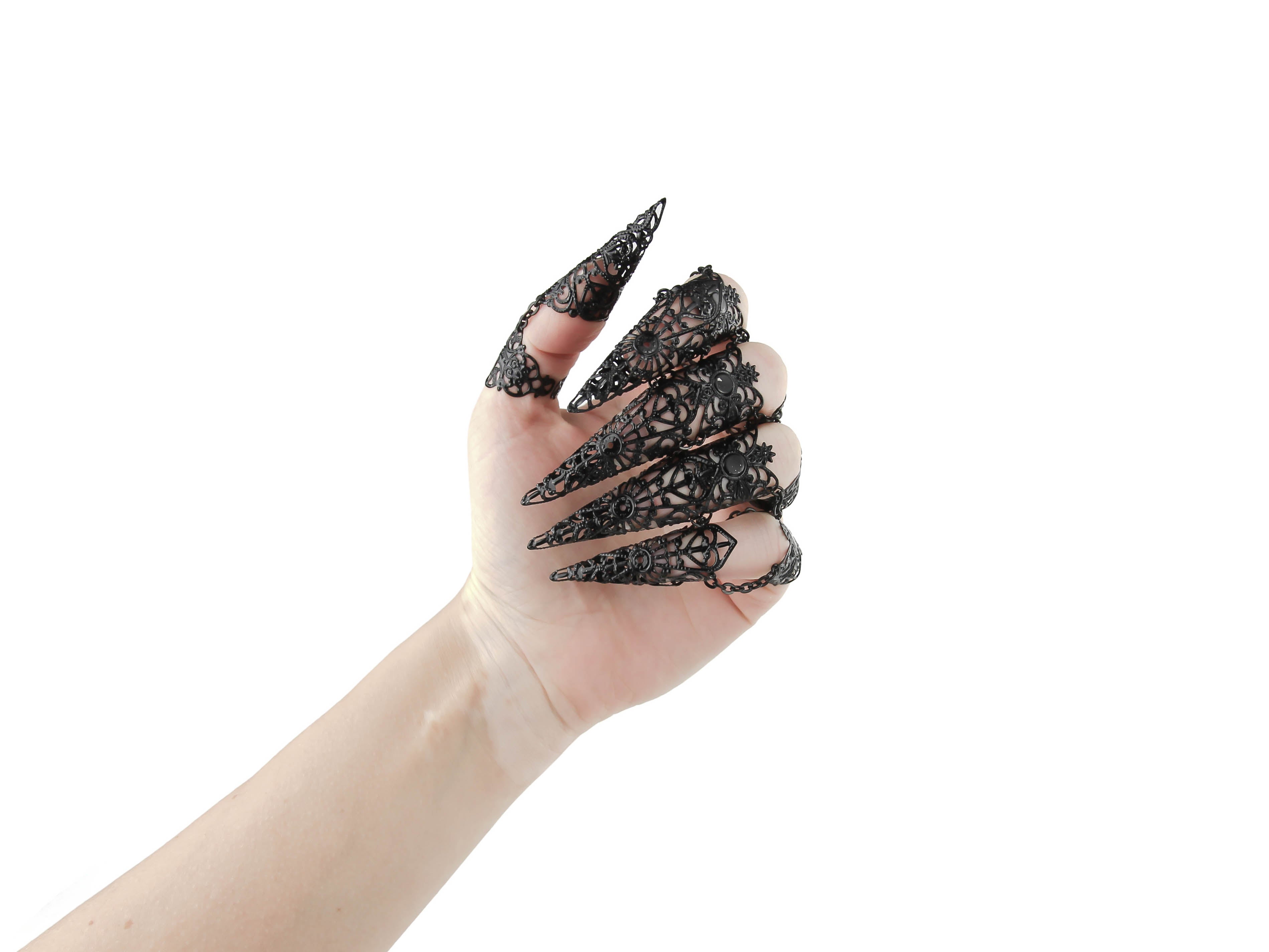 Unleash your inner goth with Myril Jewels' full hand set of black armored claw rings, intricately designed for the bold and the avant-garde. These striking silver filigree rings are perfect for a dramatic Halloween look, Neo Gothic fashion, and Gothic-chic ensembles. They cater to the whimsigoth and witchcore aesthetic, offering a standout accessory for everyday wear, minimal goth stylings, and are also ideal for drag queens and performance art