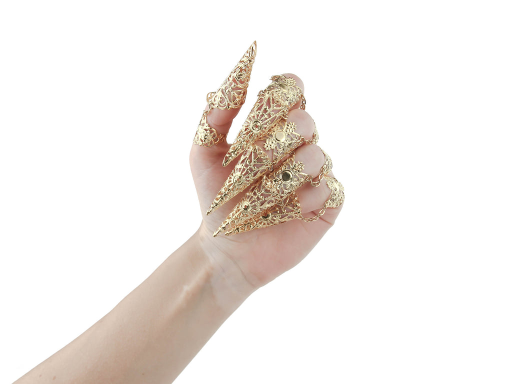 Discover the bold world of Myril Jewels with this full hand set of armored gold claw rings, a striking statement for the gothic and alternative fashion lover. These claw rings feature an exquisite filigree design, ideal for Halloween, punk, Neo Gothic, and Gothic-chic enthusiasts. The intricate metalwork adds a dramatic touch, perfect for whimsigoth and witchcore aesthetics, as well as for adding an edge to minimal goth daily wear or making a splash in drag performances