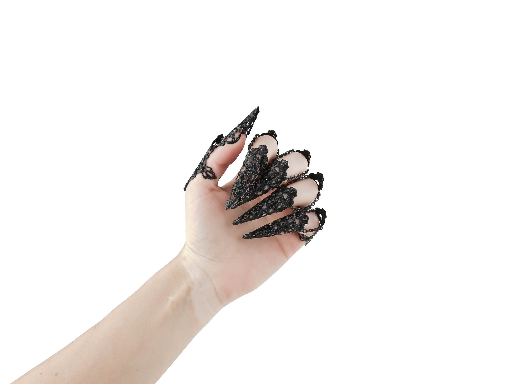 A hand is elegantly displayed, adorned with Myril Jewels' full set of ornate black rings with nail claws. These neo-goth pieces are the quintessence of gothic-chic, designed for those who favor dark, avant-garde jewelry, suitable for Halloween, festival wear, or as a striking everyday accessory