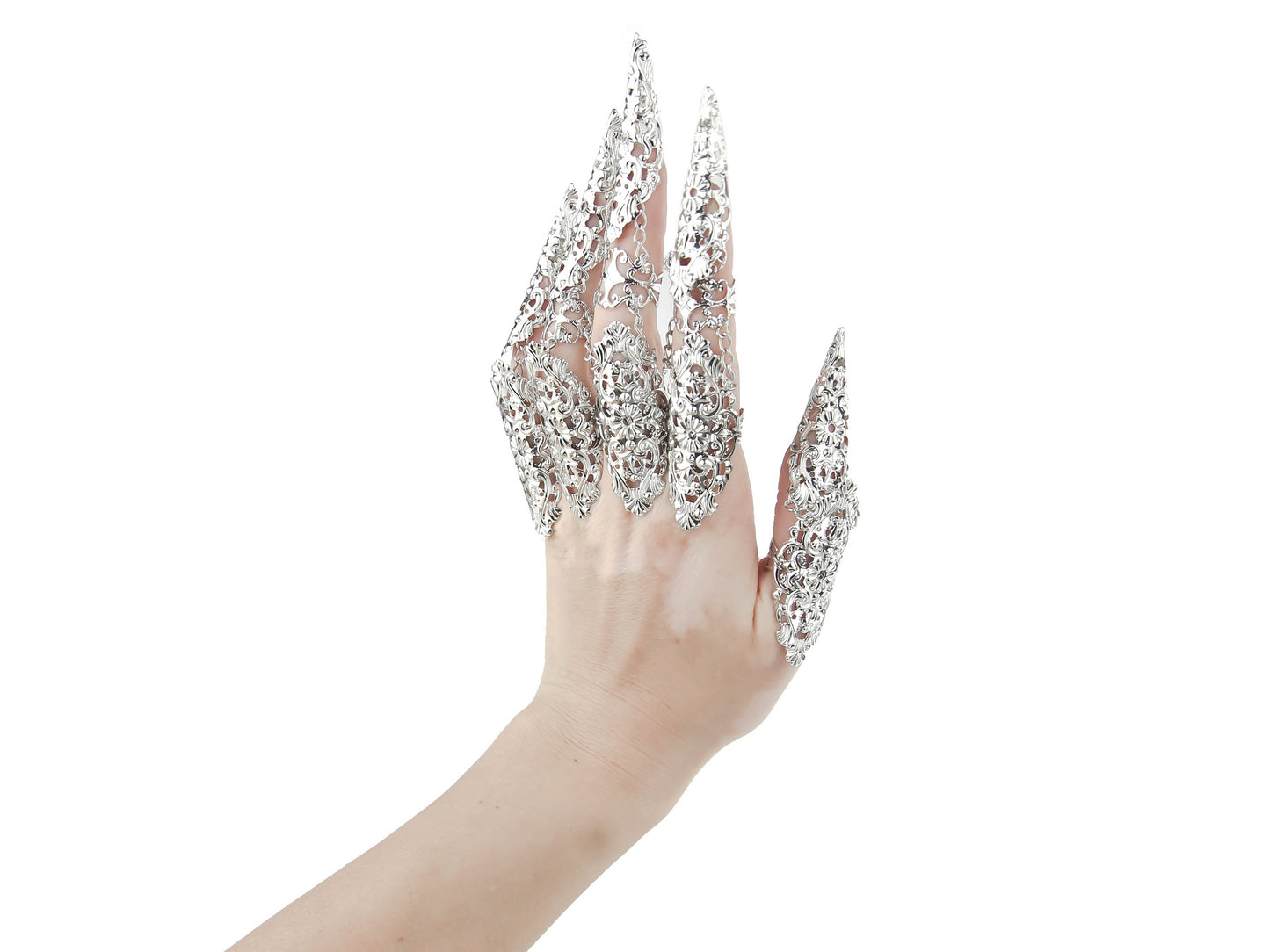 A hand is strikingly adorned with Myril Jewels' silver filigree finger armor, a neo-gothic masterpiece perfect for a whimsigoth or witchcore aesthetic. Ideal for Halloween, punk events, or gothic-chic occasions, this jewelry evokes an air of dark elegance and alternative sophistication.