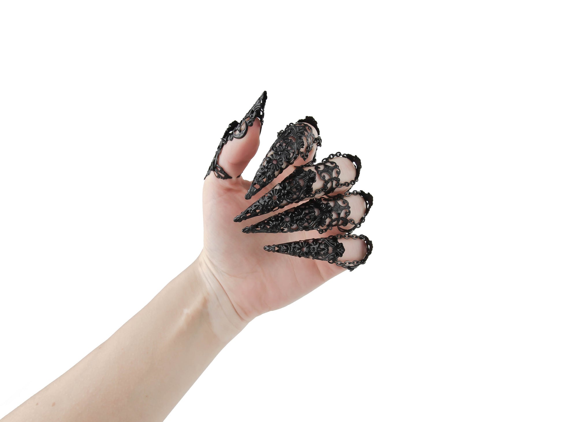 Dramatic Myril Jewels black finger armor rings, embracing a neo-gothic design, adorn a almost closed hand against a white backdrop. Perfect for gothic-chic, punk, and witchcore enthusiasts, these rings are a bold choice for Halloween events or to add an avant-garde edge to any outfit.