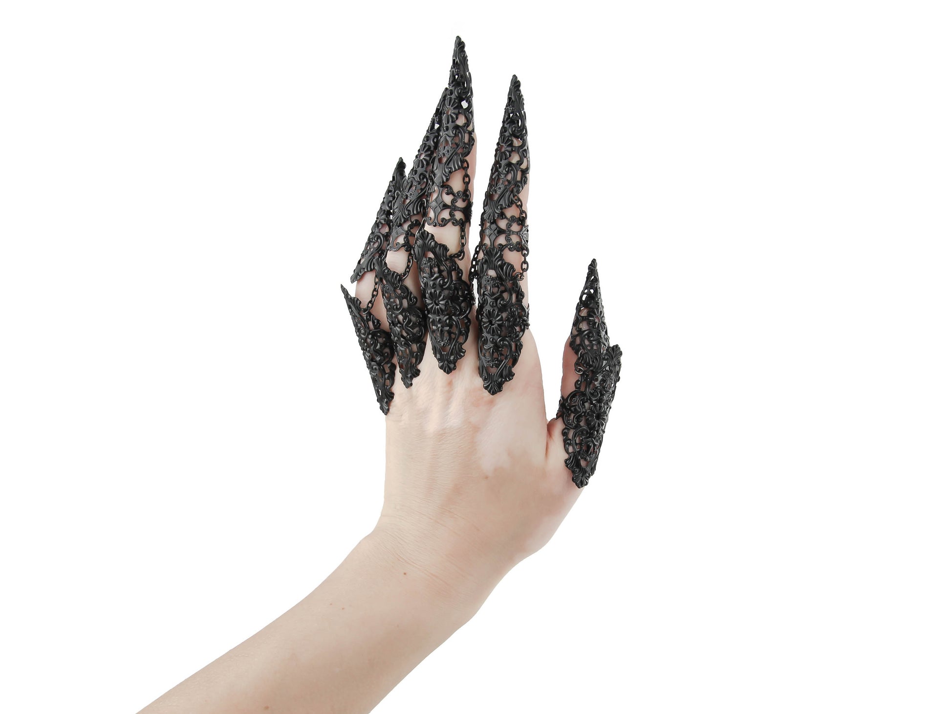 Dramatic Myril Jewels black finger armor rings, embracing a neo-gothic design, adorn a hand against a white backdrop. Perfect for gothic-chic, punk, and witchcore enthusiasts, these rings are a bold choice for Halloween events or to add an avant-garde edge to any outfit.