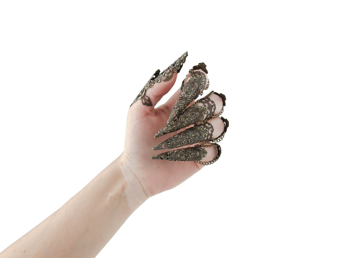 The rear of a hand strikingly showcases Myril Jewels' bronze metal lace finger armor rings, a bold statement accessory aligning with the Neo Gothic and Witchcore aesthetics. Ideal for Halloween, Gothic-chic events, or everyday wear for Punk and Gothic Lolita enthusiasts, these handcrafted rings are a hallmark of whimsigoth elegance.