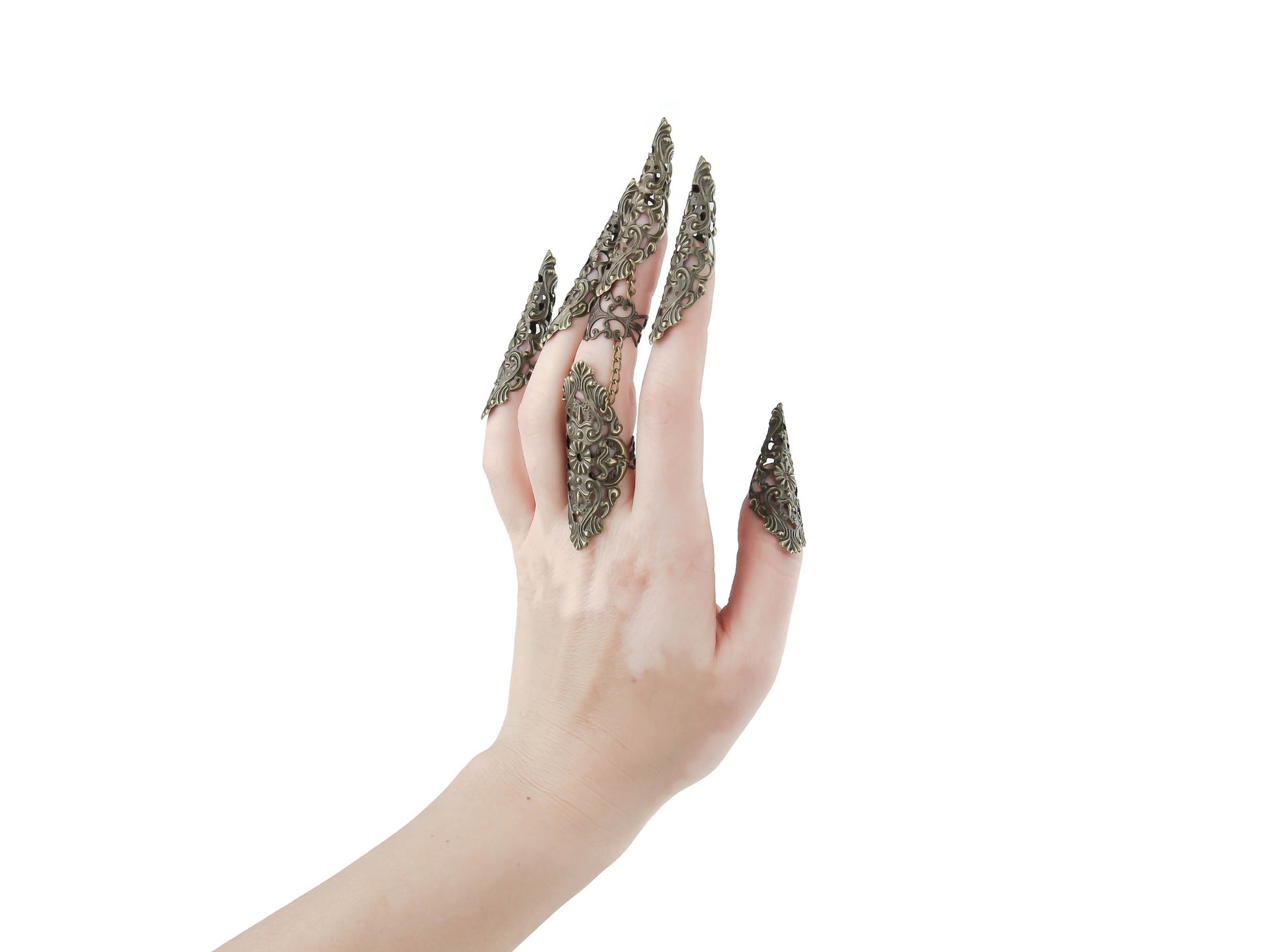 A hand is adorned with Myril Jewels' distinctive bronze full finger claw ring and bronze metal claws, crafted with exquisite detail, embodying the brand's dark-avantgarde essence. The bronze finish of the jewelry showcases neo-gothic artistry, perfect for gothic-chic enthusiasts or as a bold statement for Halloween. These pieces are versatile for everyday wear, yet bold enough for rave party jewelry or festival style, reflecting Myril's commitment to the whimsigoth and witchcore aesthetics