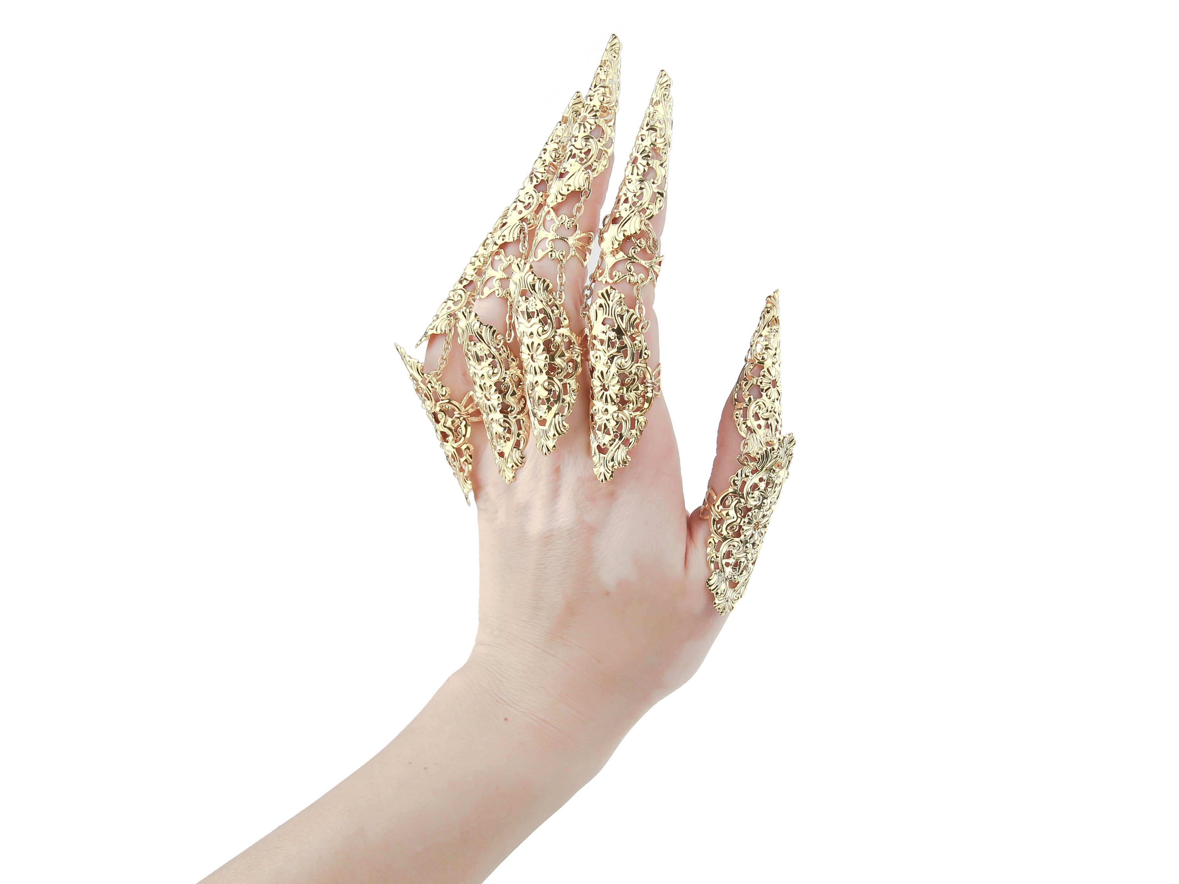 A hand is strikingly adorned with Myril Jewels' dark, gothic-chic finger armor rings in gold tone, intricately designed with a whimsigoth lace pattern. Perfect for Halloween, punk, and neo-gothic styles, or as a bold witchcore statement piece, these rings embody a fusion of gothic lolita elegance and alternative fashion.