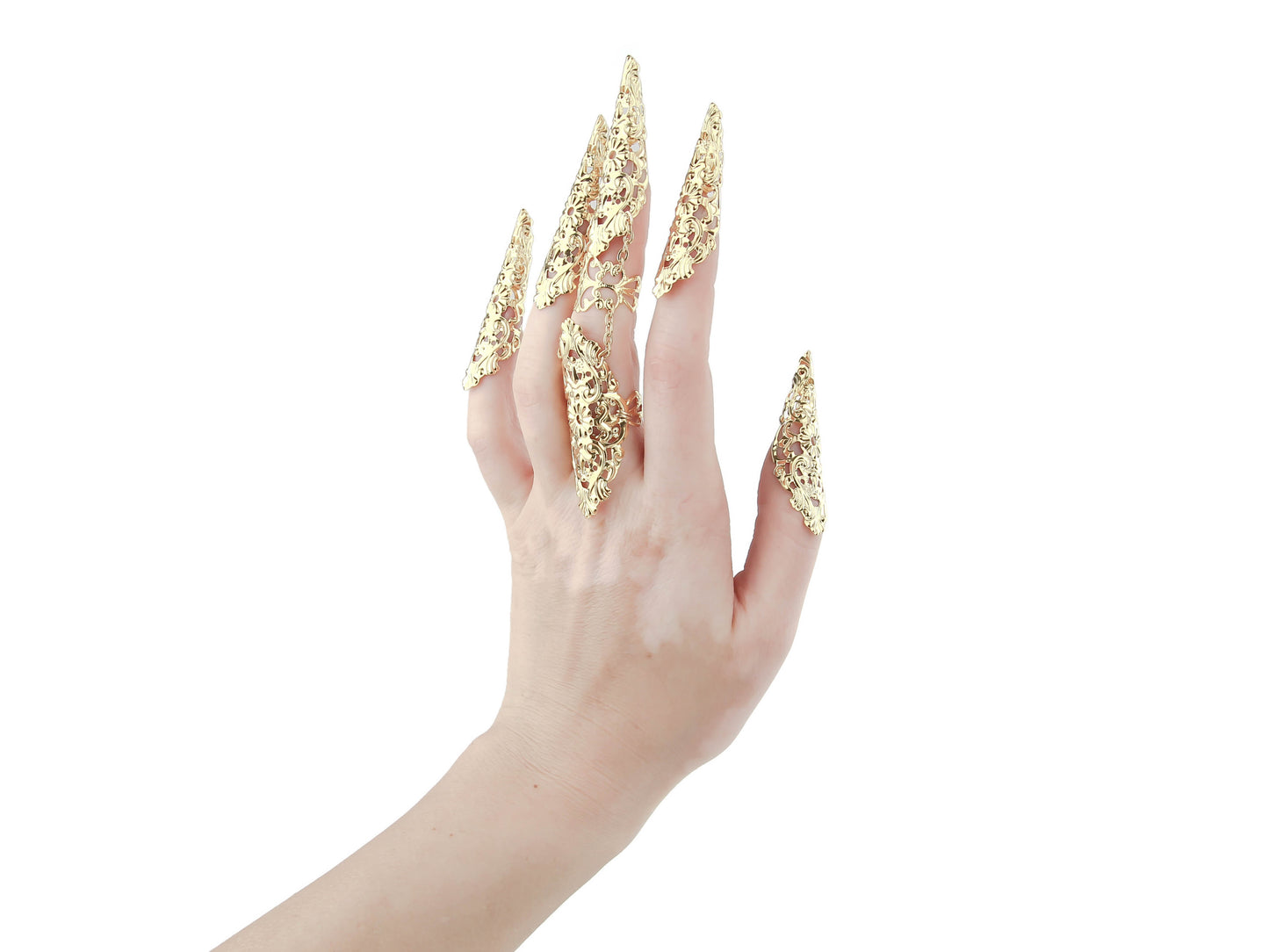 A hand is adorned with Myril Jewels' striking full-finger gold claw ring on the middle finger and gold metal claws on the other four, all crafted with intricate filigree. This bold piece is a testament to the neo-goth jewelry aesthetic, perfect for those who favor a dark-avantgarde, gothic-chic look. Ideal for Halloween, punk fashion, and whimsigoth styles, it's also suited for everyday wear or as a dramatic accessory for rave parties and festivals