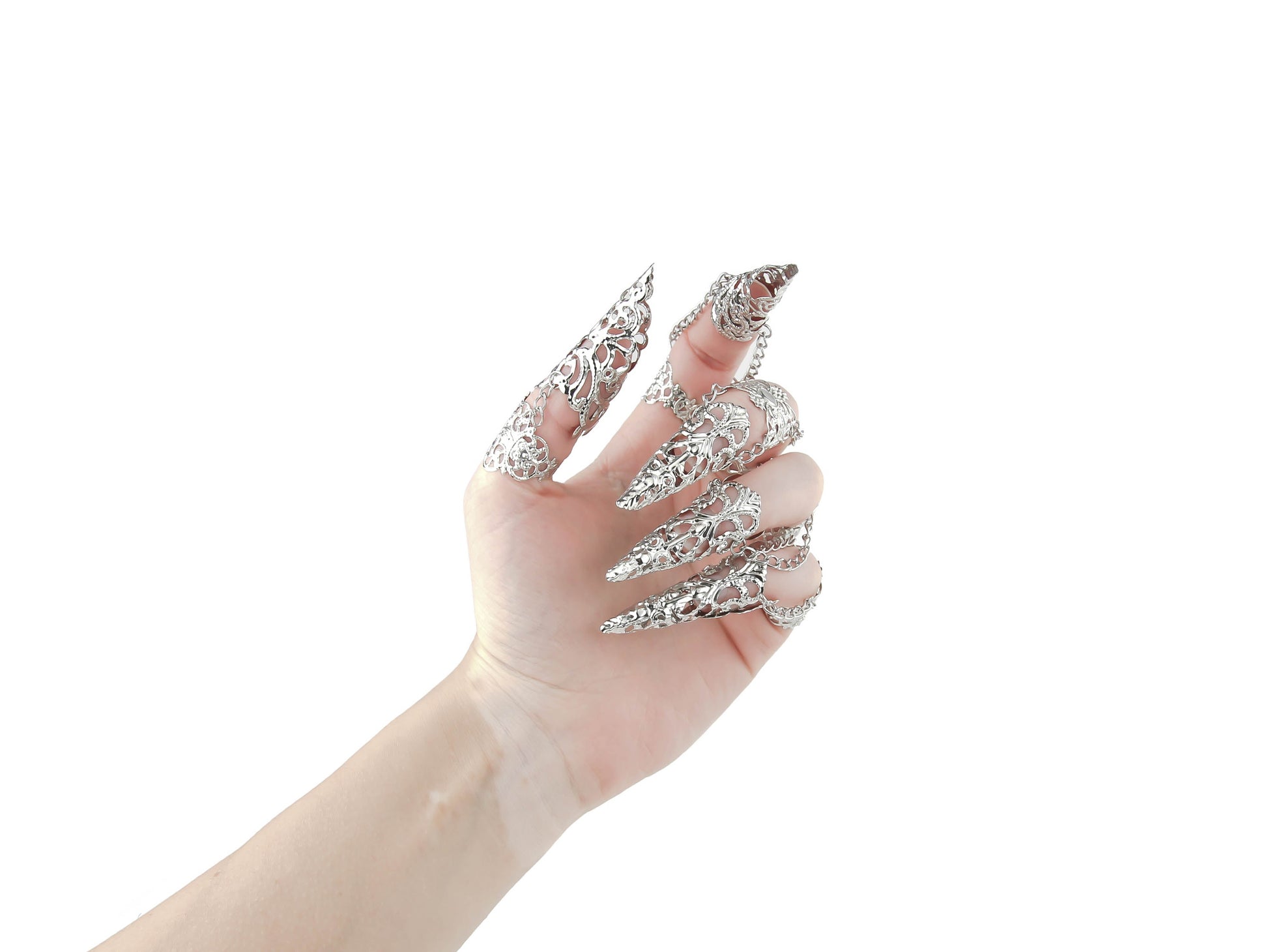A hand is dramatically enhanced with a full set of Myril Jewels silver claw rings, each finger adorned with an elaborate filigree design that embodies the essence of neo-goth fashion. This dark-avantgarde accessory set is perfect for gothic, witchcore, and whimsigoth enthusiasts, making a bold statement for Halloween, everyday wear, or as captivating rave party and festival jewels.