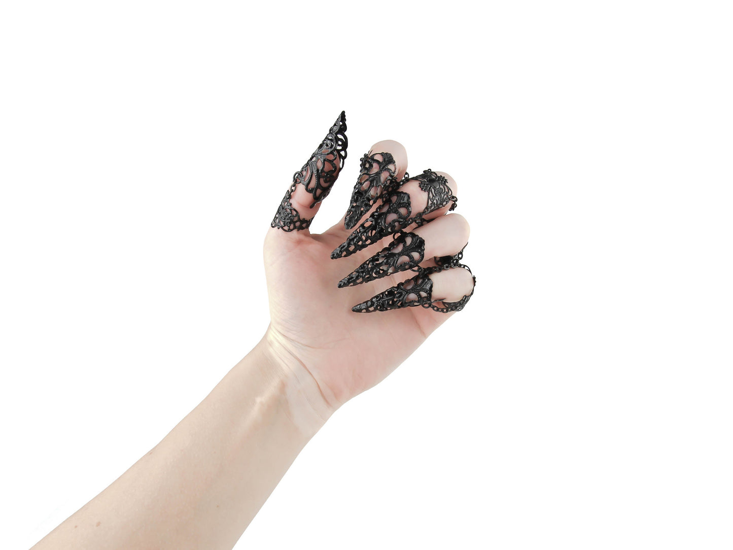 A hand is elegantly adorned with a full set of Myril Jewels claw rings, each finger crowned with an intricate, black lace-like filigree design that evokes the neo-goth spirit. This dark-avantgarde accessory is a perfect embodiment of gothic-chic, ideal for adding a dramatic flair to Halloween attire or as a standout addition to any minimal goth, whimsigoth, or witchcore ensemble. These claw rings are not only a bold statement for rave parties and festivals but also add an edge to everyday wear.