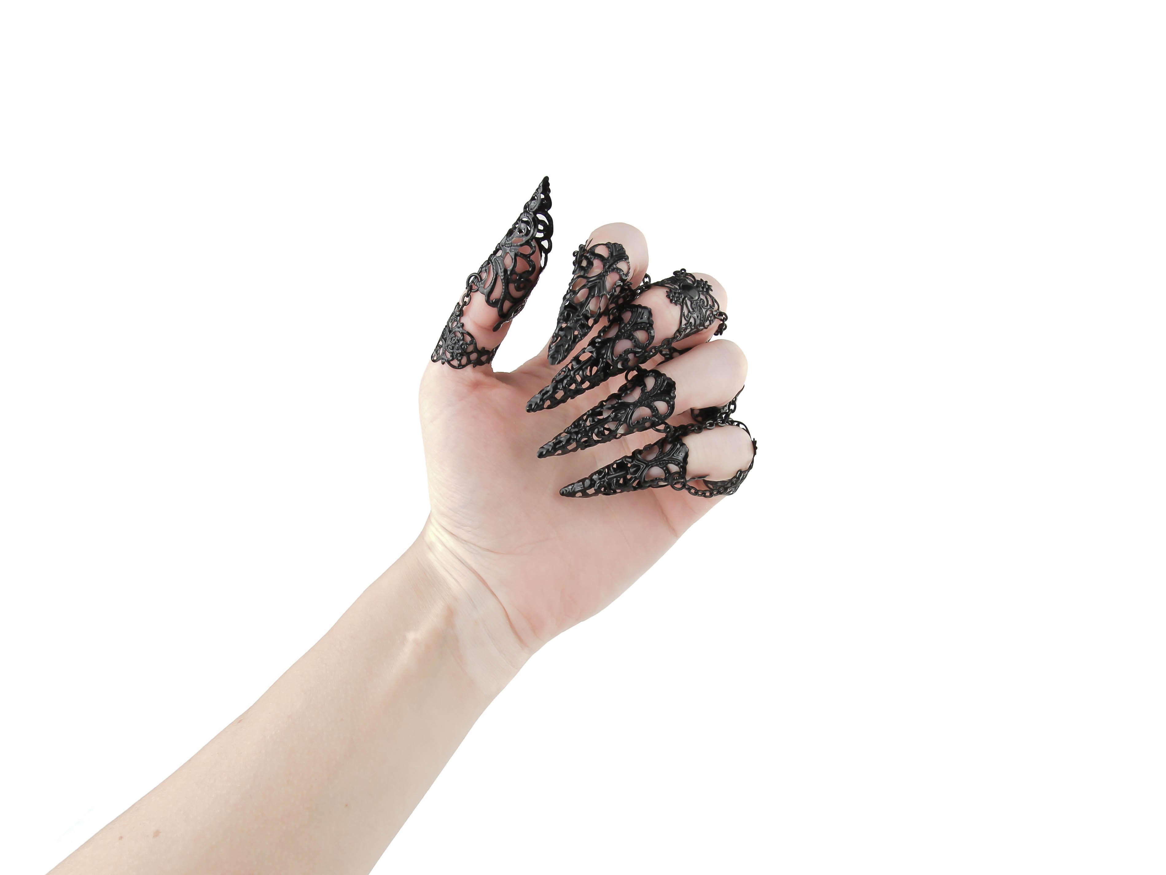 A hand is elegantly adorned with a full set of Myril Jewels claw rings, each finger crowned with an intricate, black lace-like filigree design that evokes the neo-goth spirit. This dark-avantgarde accessory is a perfect embodiment of gothic-chic, ideal for adding a dramatic flair to Halloween attire or as a standout addition to any minimal goth, whimsigoth, or witchcore ensemble. These claw rings are not only a bold statement for rave parties and festivals but also add an edge to everyday wear.