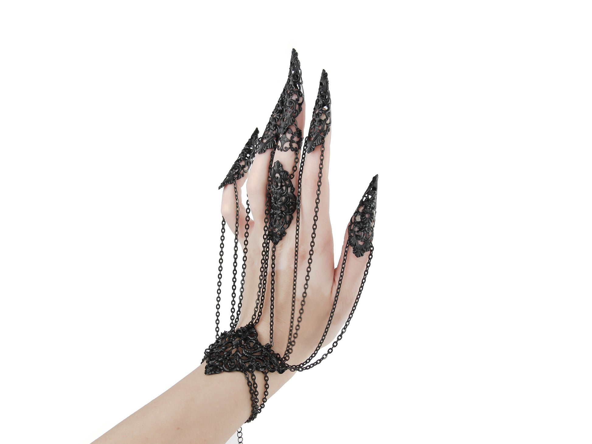 Elevate your style with this Myril Jewels black hand chain bracelet, a vision of neo-goth craftsmanship. Each black chain drapes elegantly from a wrist cuff to filigree claw rings, perfect for gothic-chic fashion lovers and a standout choice for bold everyday wear.
