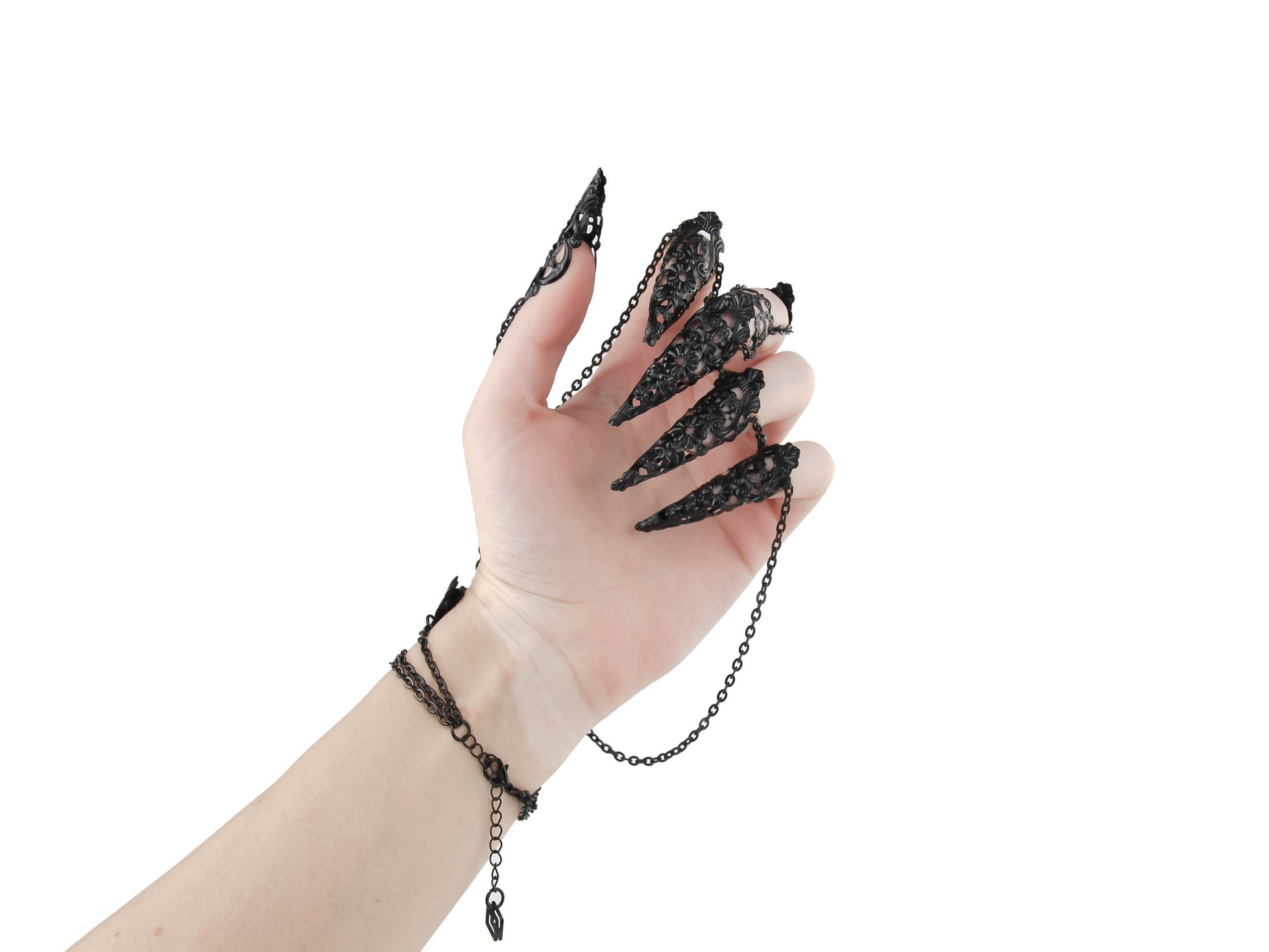Elevate your style with this Myril Jewels black hand chain bracelet, a vision of neo-goth craftsmanship. Each black chain drapes elegantly from a wrist cuff to filigree claw rings, perfect for gothic-chic fashion lovers and a standout choice for bold everyday wear.