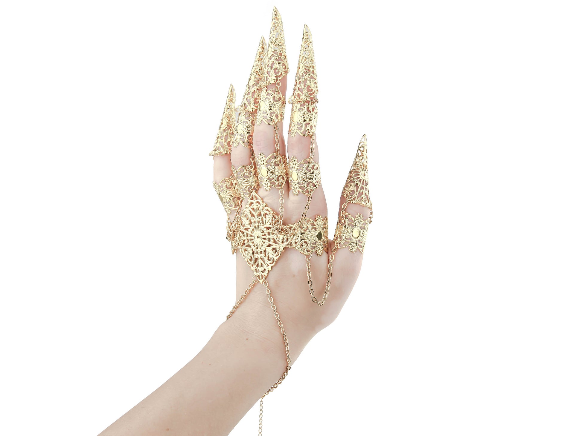 A hand is elevated to display a gold full hand metal glove with intricate gold claw rings by Myril Jewels, merging neo-gothic artistry with a dark avant-garde twist. Ideal for gothic, punk, and alternative style aficionados, this piece is a bold addition to any Halloween or festival ensemble.