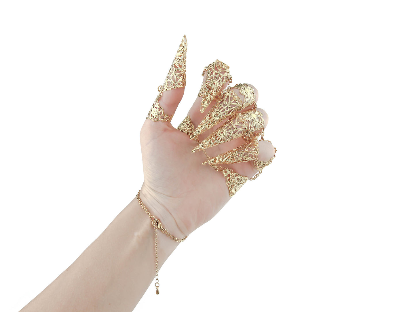A hand is elevated to display a gold full hand metal glove with intricate gold claw rings by Myril Jewels, merging neo-gothic artistry with a dark avant-garde twist. Ideal for gothic, punk, and alternative style aficionados, this piece is a bold addition to any Halloween or festival ensemble.