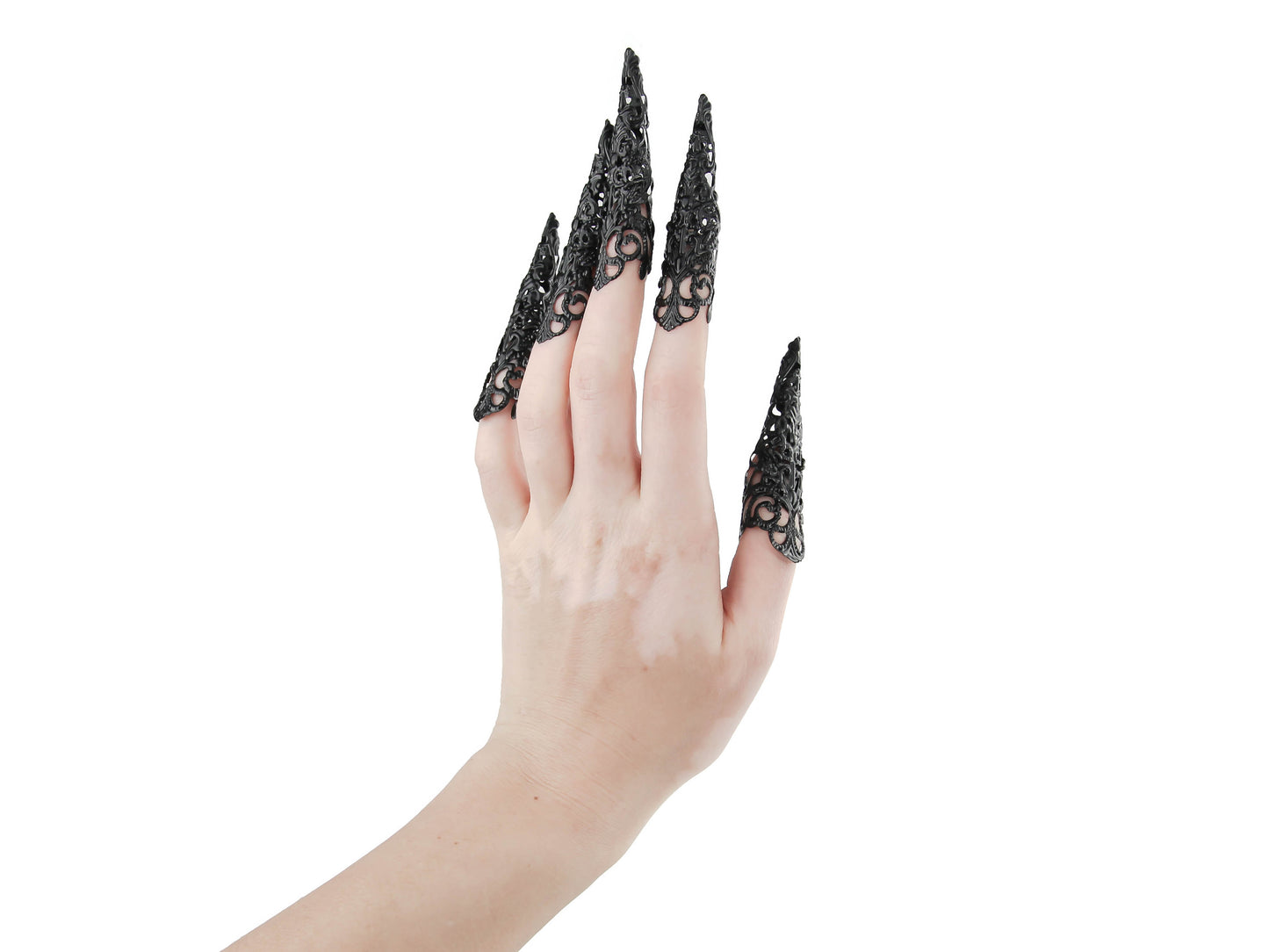Captivating full hand set of Myril Jewels' extra long black nail claw rings showcased on a delicate hand. These neo-gothic claws are perfect for a dramatic goth-chic look, making a bold statement for Halloween, enhancing a rave party outfit, or as a memorable gift for the goth girlfriend with a love for dark avant-garde fashion.