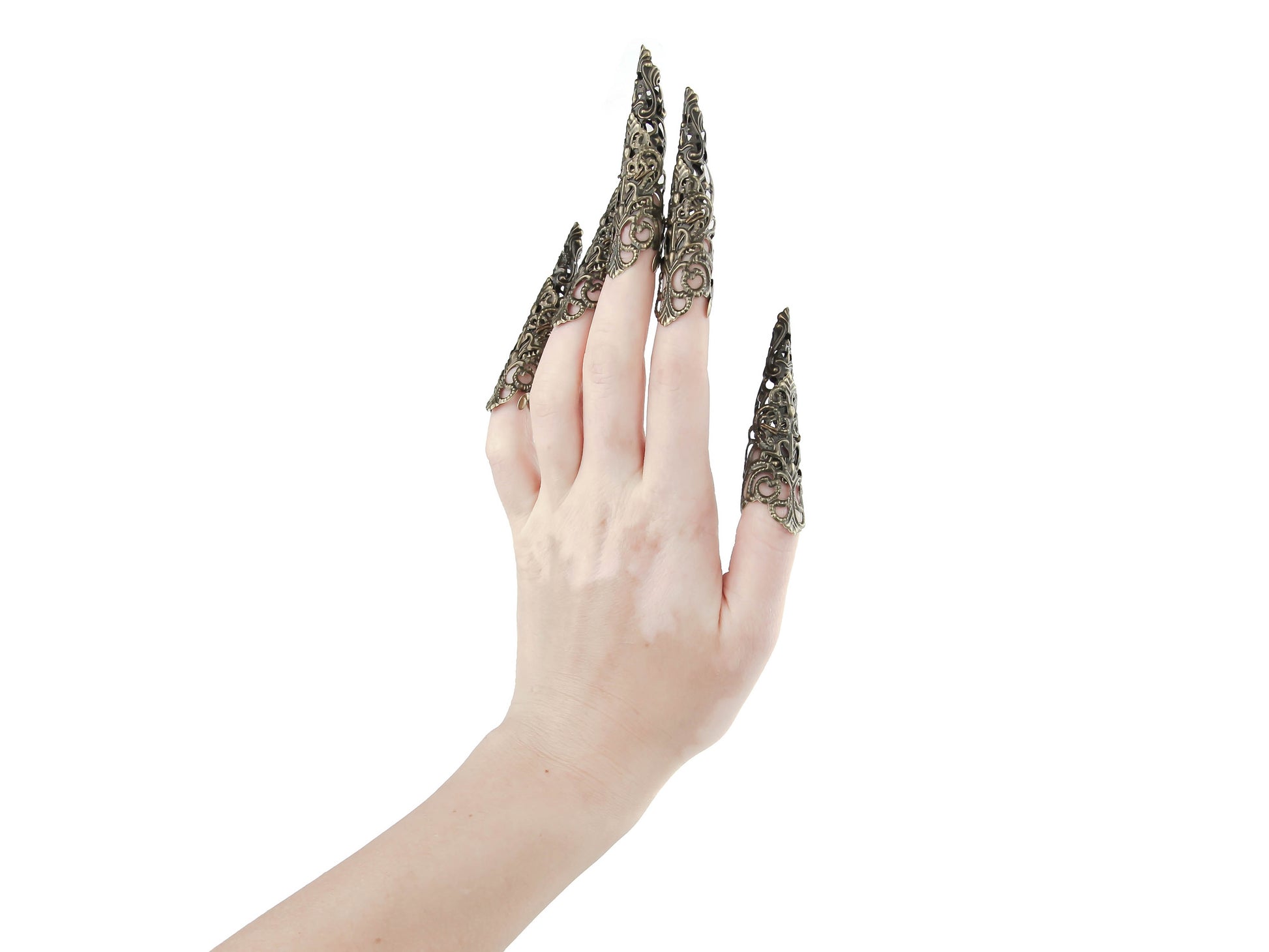 A full hand set of extra-long, intricately designed nail claws from Myril Jewels exudes a dark, neo-goth elegance. Ideal for Halloween, these claws are a bold choice for those who love punk jewelry, whimsigoth style, or witchcore. They're perfect for adding an avant-garde touch to everyday wear or as a statement at rave parties and festivals. These claws are also a unique gift idea for a goth girlfriend.