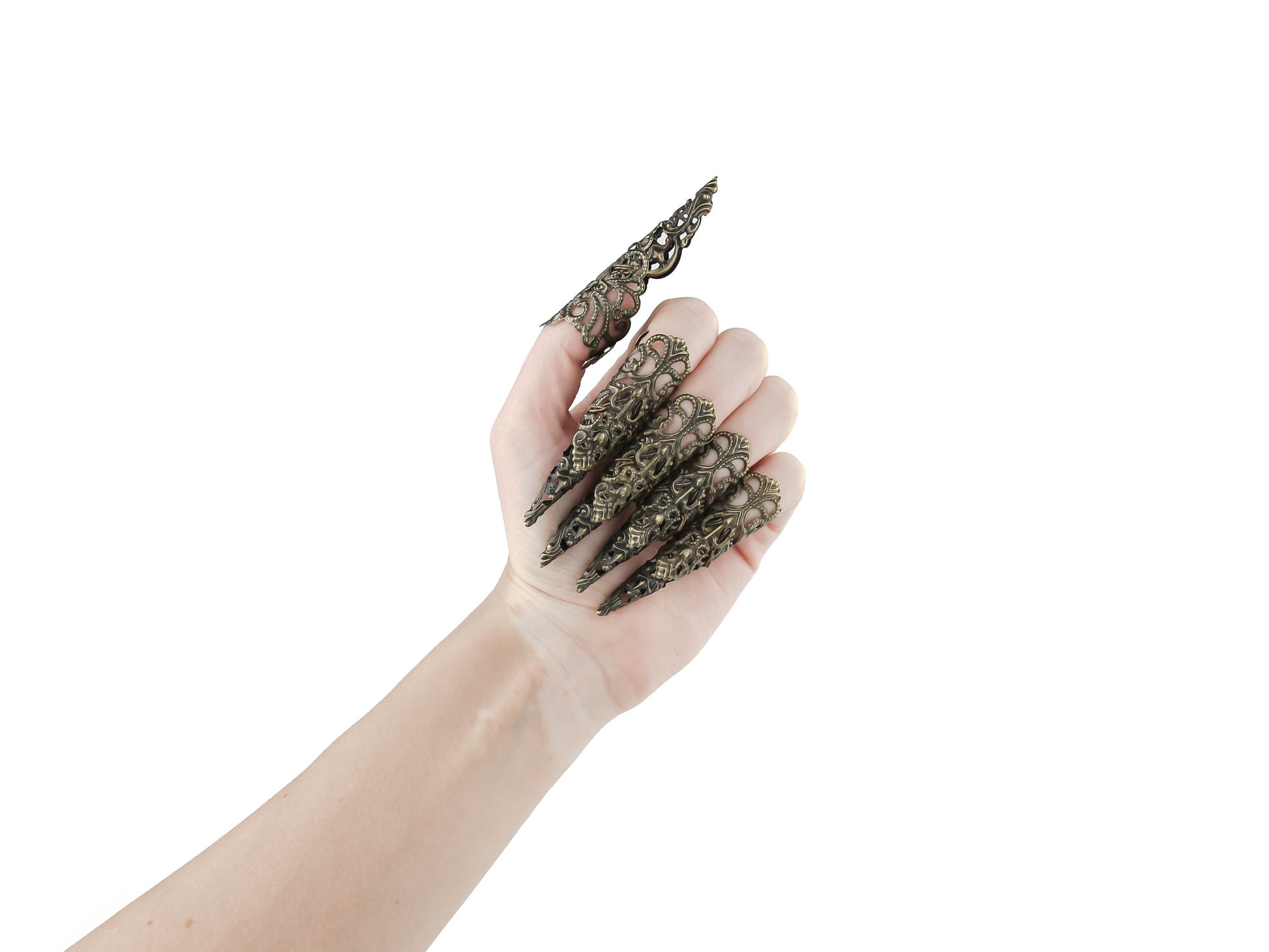 A full hand set of extra-long, intricately designed nail claws from Myril Jewels exudes a dark, neo-goth elegance. Ideal for Halloween, these claws are a bold choice for those who love punk jewelry, whimsigoth style, or witchcore. They're perfect for adding an avant-garde touch to everyday wear or as a statement at rave parties and festivals. These claws are also a unique gift idea for a goth girlfriend.