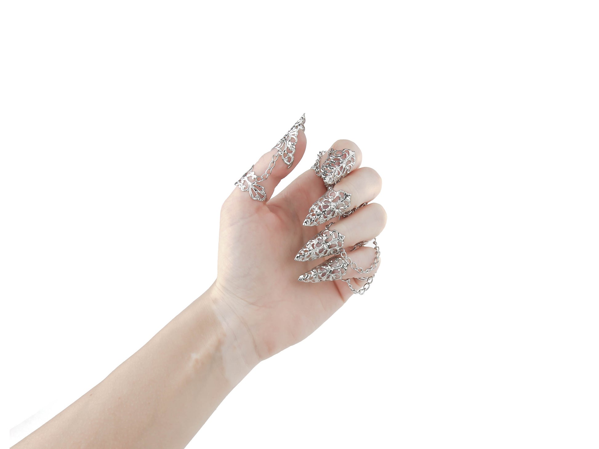  Displayed is a stunning full hand set of Myril Jewels claw rings, designed for the dark-avantgarde enthusiast. The rings feature intricate silver filigree that delicately wraps around each finger, culminating in sharp, claw-like tips, perfect for a Gothic-chic or Witchcore look. These handcrafted pieces are ideal for Halloween, adding a bold statement to minimal goth daily wear, and are a dazzling choice for rave party jewelry or festival adornment, reflecting the unique artistry of Neo Gothic jewels.