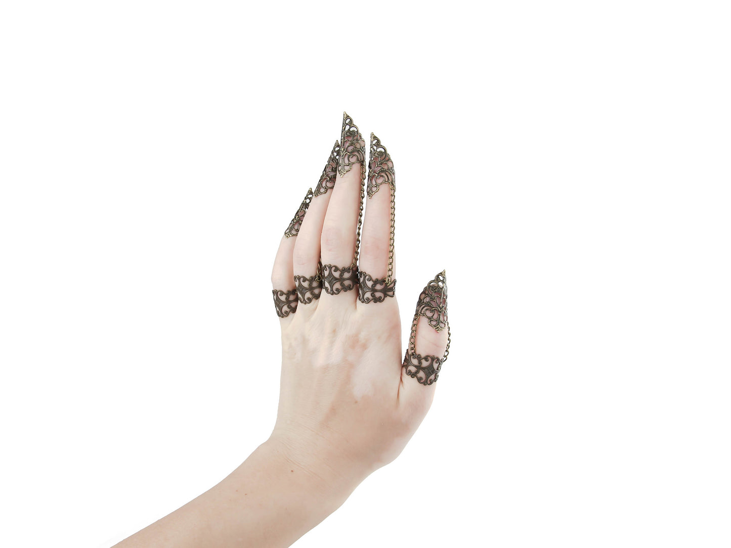 A hand adorned with Myril Jewels' full set of bronze claw rings, showcasing exquisite filigree detailing for a striking dark-avantgarde statement. Each ring, crafted with Neo Gothic intricacy, extends into an elegant point, perfect for Halloween, festival wear, or adding an edge to everyday minimal goth attire. This set aligns with gothic-chic and Witchcore aesthetics, reflecting the brand's commitment to unique, alternative jewelry designs.