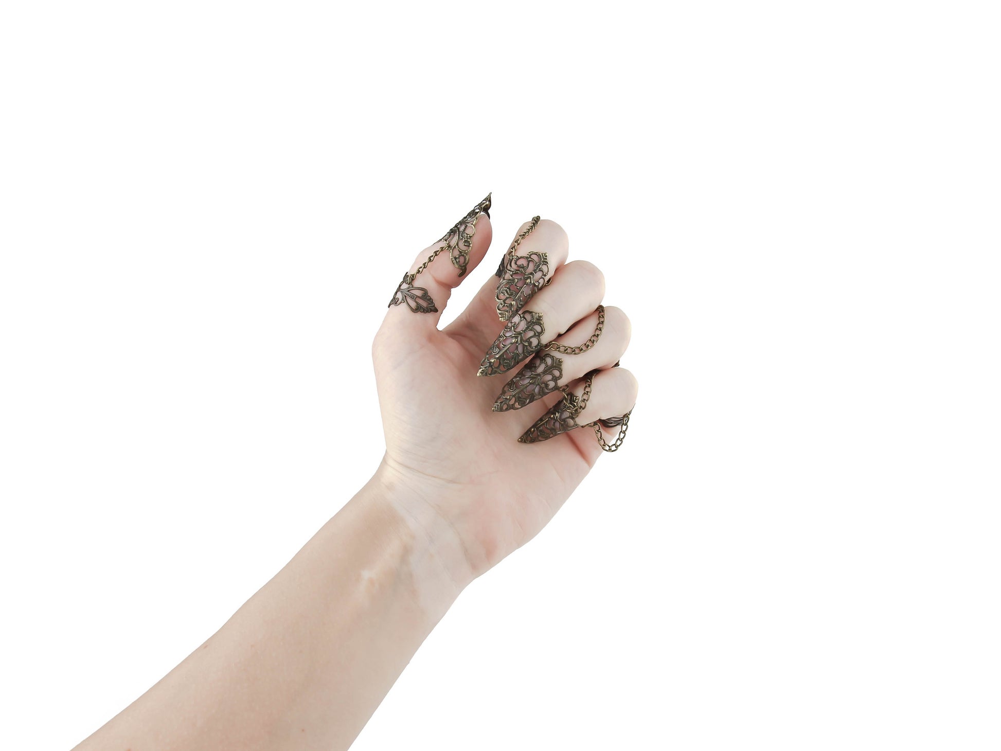 An almost closed hand adorned with Myril Jewels' full set of bronze claw rings, showcasing exquisite filigree detailing for a striking dark-avantgarde statement. Each ring, crafted with Neo Gothic intricacy, extends into an elegant point, perfect for Halloween, festival wear, or adding an edge to everyday minimal goth attire. This set aligns with gothic-chic and Witchcore aesthetics, reflecting the brand's commitment to unique, alternative jewelry designs.