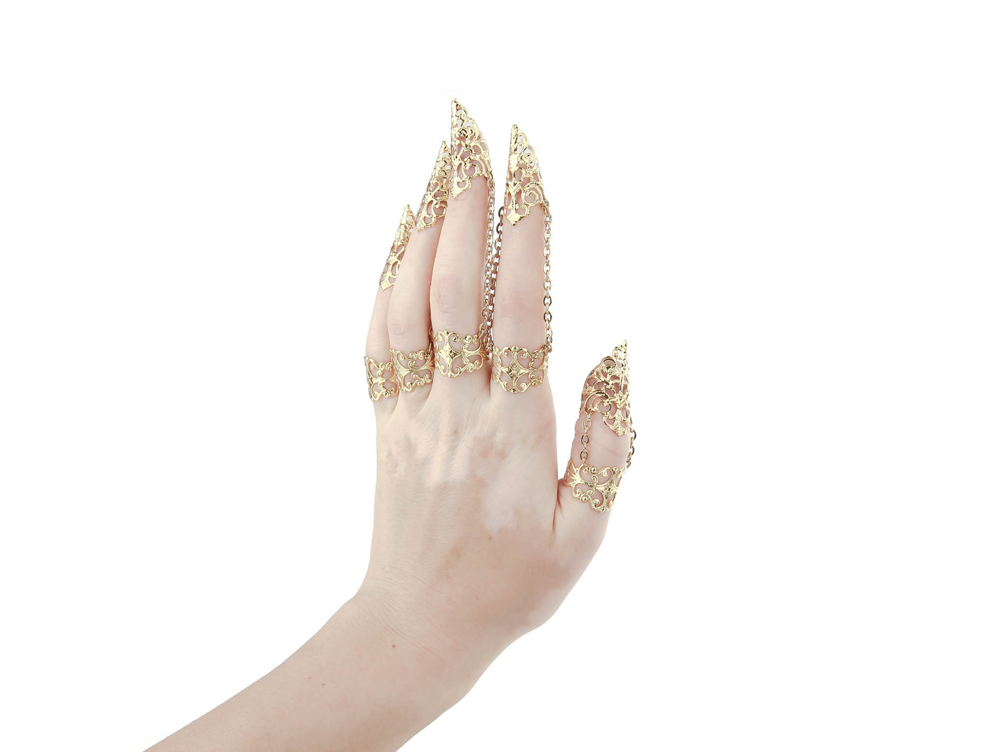 A hand elegantly displays Myril Jewels' full set of gold claw rings, each piece featuring ornate filigree designs that evoke Neo Gothic sophistication. Ideal for those with a love for Gothic-chic and dark-avantgarde aesthetics, this set complements Halloween outfits and adds an edge to everyday wear. It's a stunning choice for minimal goth enthusiasts or as standout rave party jewelry, capturing the Witchcore spirit and festival jewel trends