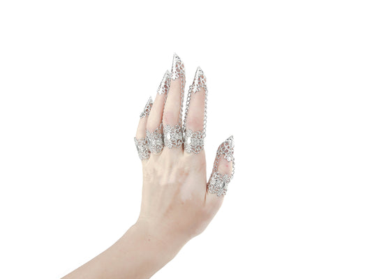 A hand models a full set of intricate claw rings from Myril Jewels, epitomizing the neo-goth aesthetic. Perfect for those drawn to dark, avant-garde fashion, these rings are a match for Halloween, punk styles, and gothic-chic looks. Suitable for witchcore, everyday wear, or as statement jewelry at raves and festivals, they make a bold gift for a goth girlfriend or anyone who adores unique, handcrafted accessories.