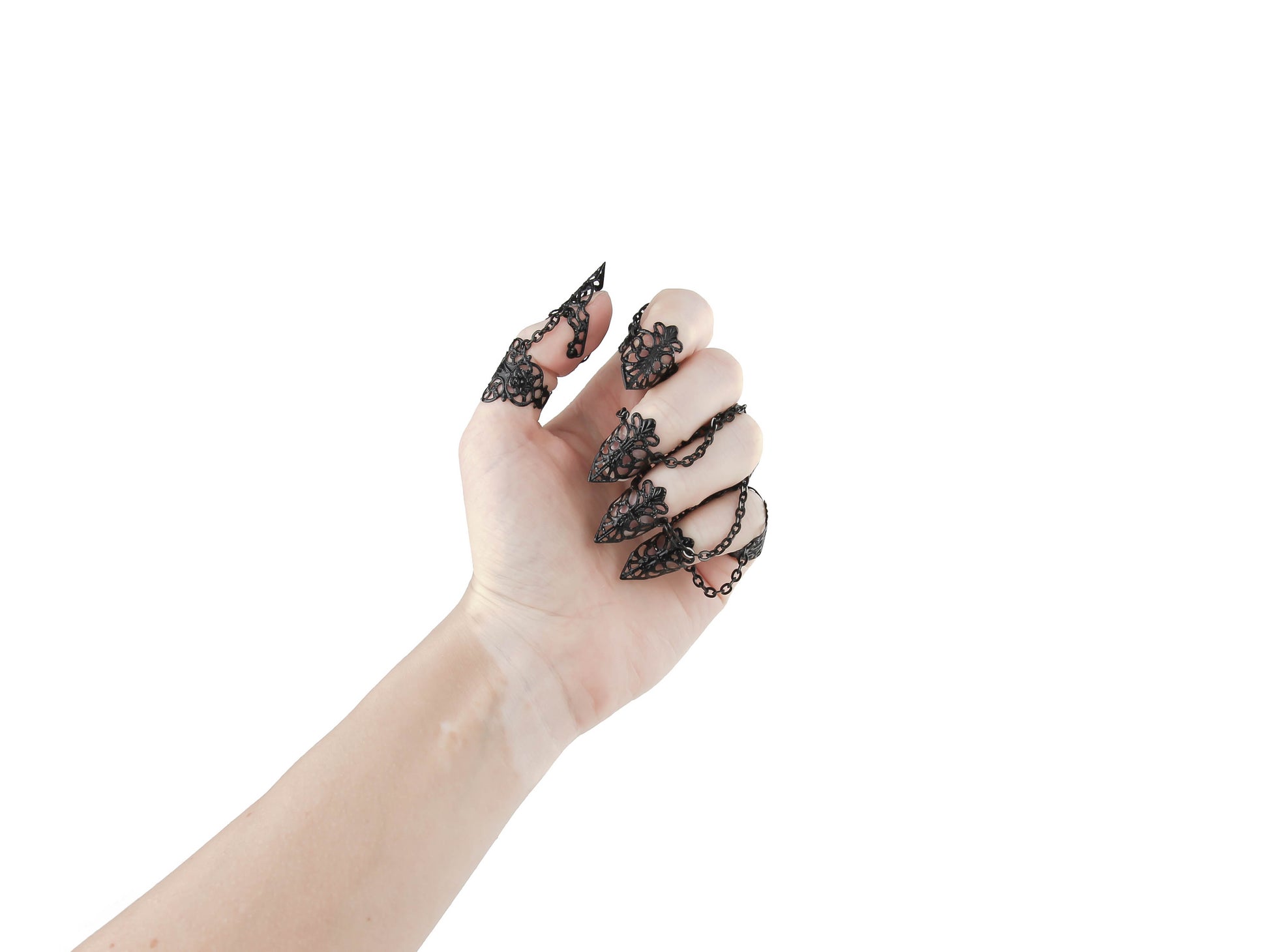 A hand is elegantly displayed, adorned with Myril Jewels' full set of ornate black rings with nail claws. These neo-goth pieces are the quintessence of gothic-chic, designed for those who favor dark, avant-garde jewelry, suitable for Halloween, festival wear, or as a striking everyday accessory