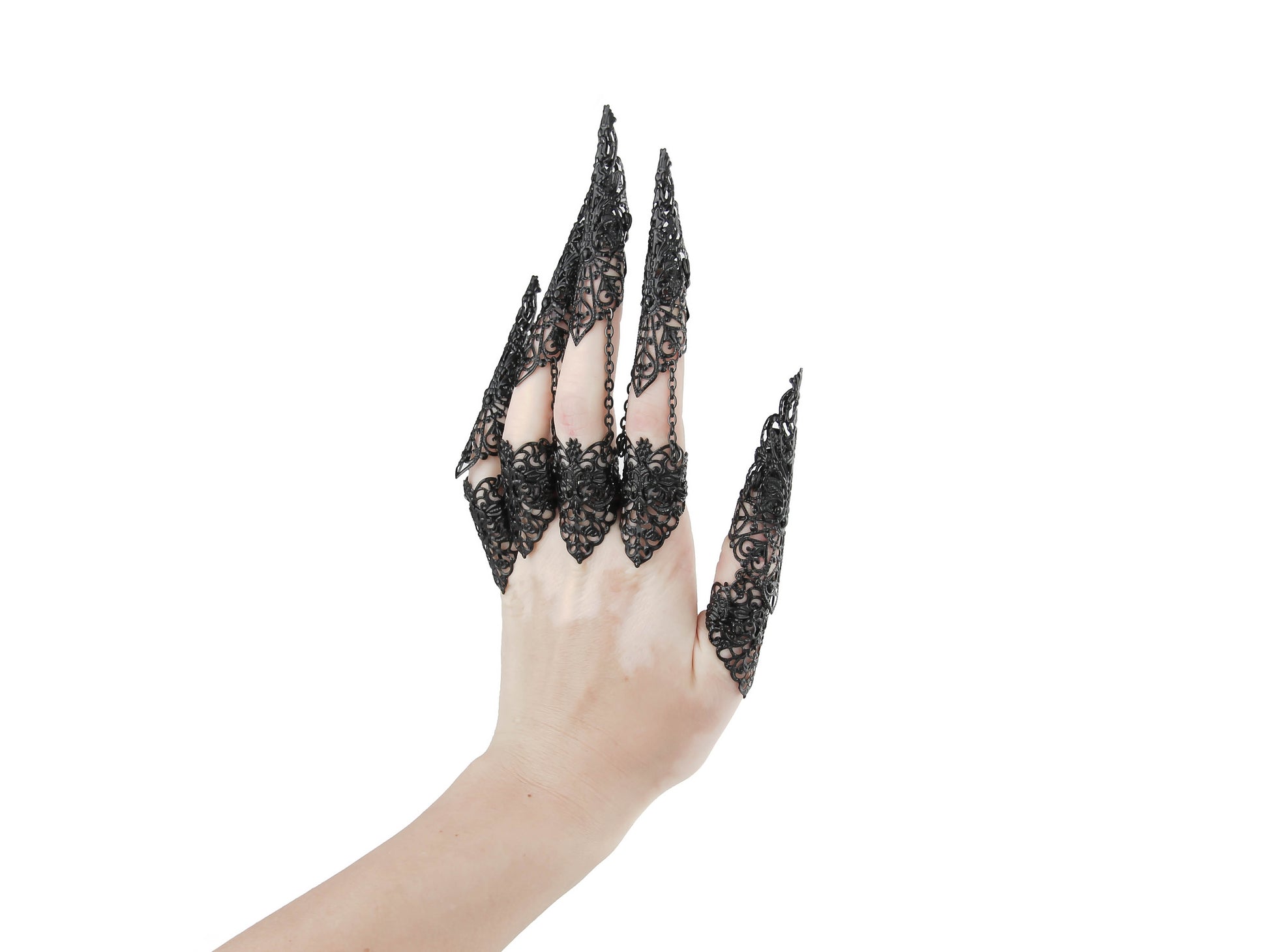 A hand adorned with Myril Jewels' full set of black armor rings, each extending into a filigree long claw, encapsulates the essence of neo-gothic elegance. These claw rings are perfect for dark-avantgarde enthusiasts, seamlessly blending with Halloween costumes or punk jewelry collections. They're also a statement piece for witchcore fashion, adding a dramatic touch to everyday wear or completing a rave party ensemble, and are striking enough for drag queen performances.