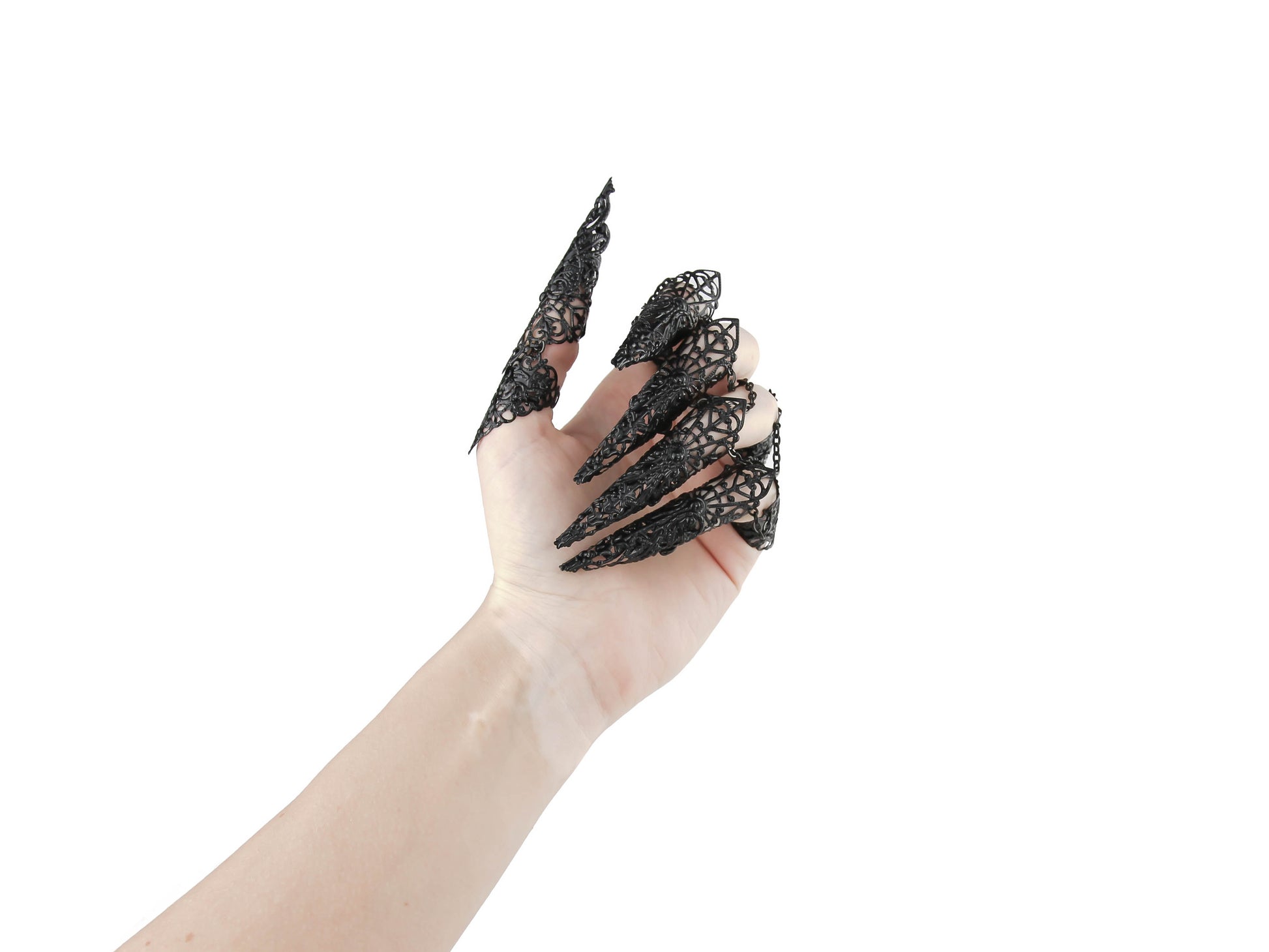 A hand adorned with Myril Jewels' full set of black armor rings, each extending into a filigree long claw, encapsulates the essence of neo-gothic elegance. These claw rings are perfect for dark-avantgarde enthusiasts, seamlessly blending with Halloween costumes or punk jewelry collections. They're also a statement piece for witchcore fashion, adding a dramatic touch to everyday wear or completing a rave party ensemble, and are striking enough for drag queen performances.