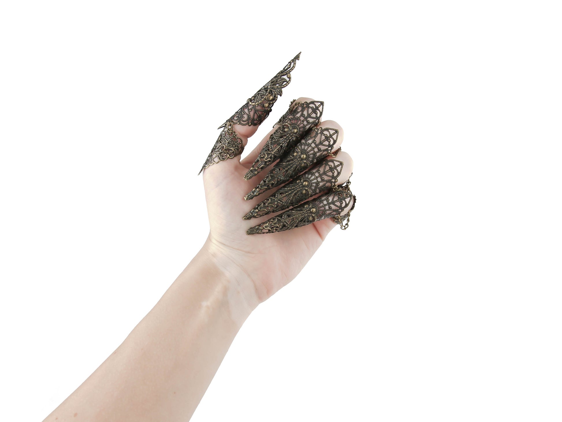 A hand is adorned with a full set of Myril Jewels bronze armor rings, each extending into elaborate long claws that showcase a fine lace-like filigree. This exquisite craftsmanship blends neo-gothic style with dark avant-garde elegance, perfect for Halloween, drag queen shows, or as a standout accessory for those who favor punk jewelry, gothic-chic, and witchcore aesthetics in their everyday and festival wear