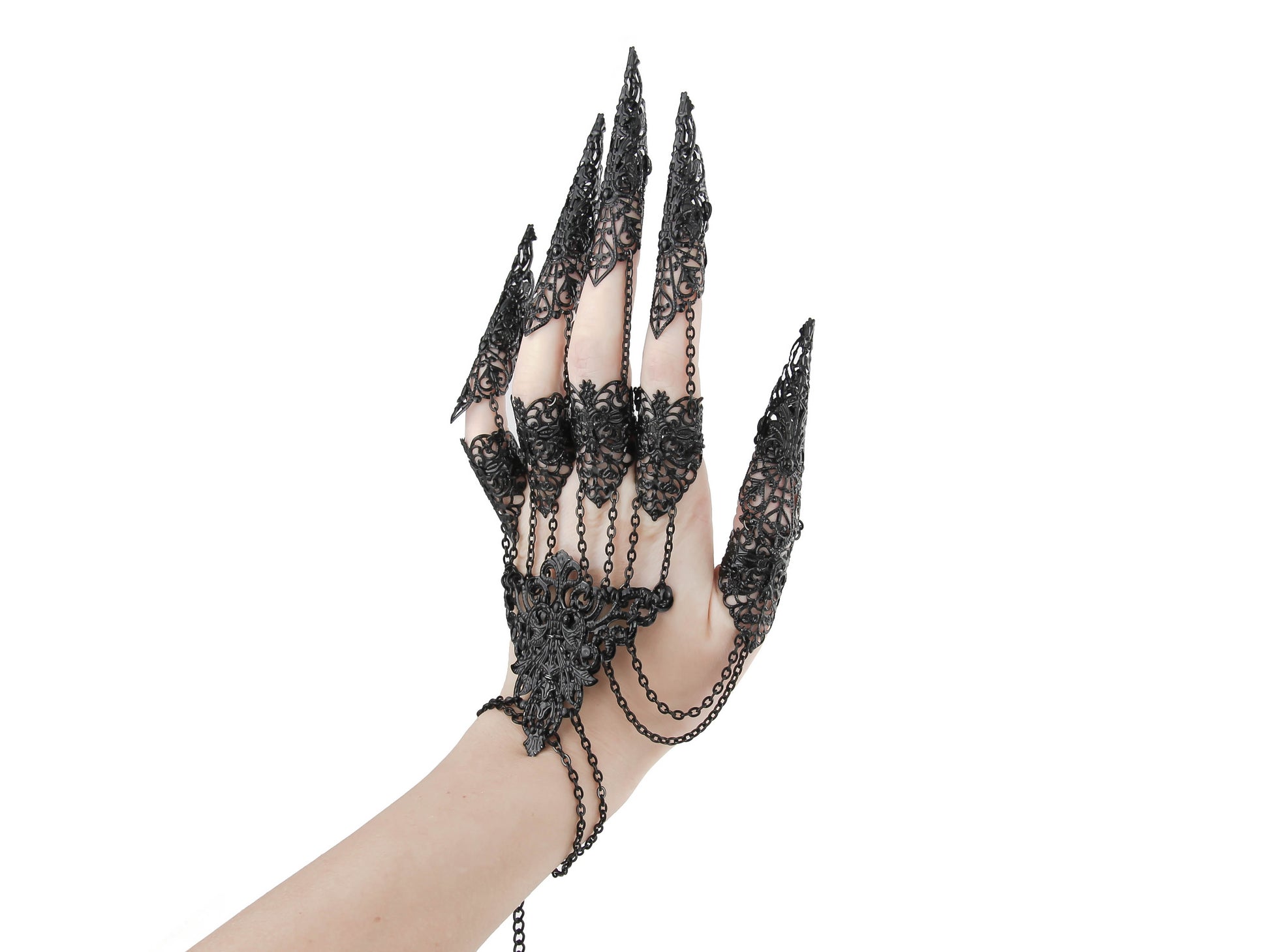A hand adorned with a striking goth jewelry piece, featuring black claw-like extensions as part of its dark fashion design. The metal glove is embellished with intricate, gothic filigree patterns and interconnected chains, perfect for an edgy, alternative look.