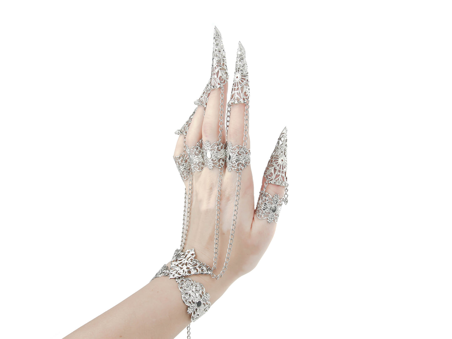 A hand adorned with silver claw rings and chain-linked full finger armor rings, showcasing a dramatic gothic jewelry style, perfect for a dark aesthetic or avant-garde fashion statement