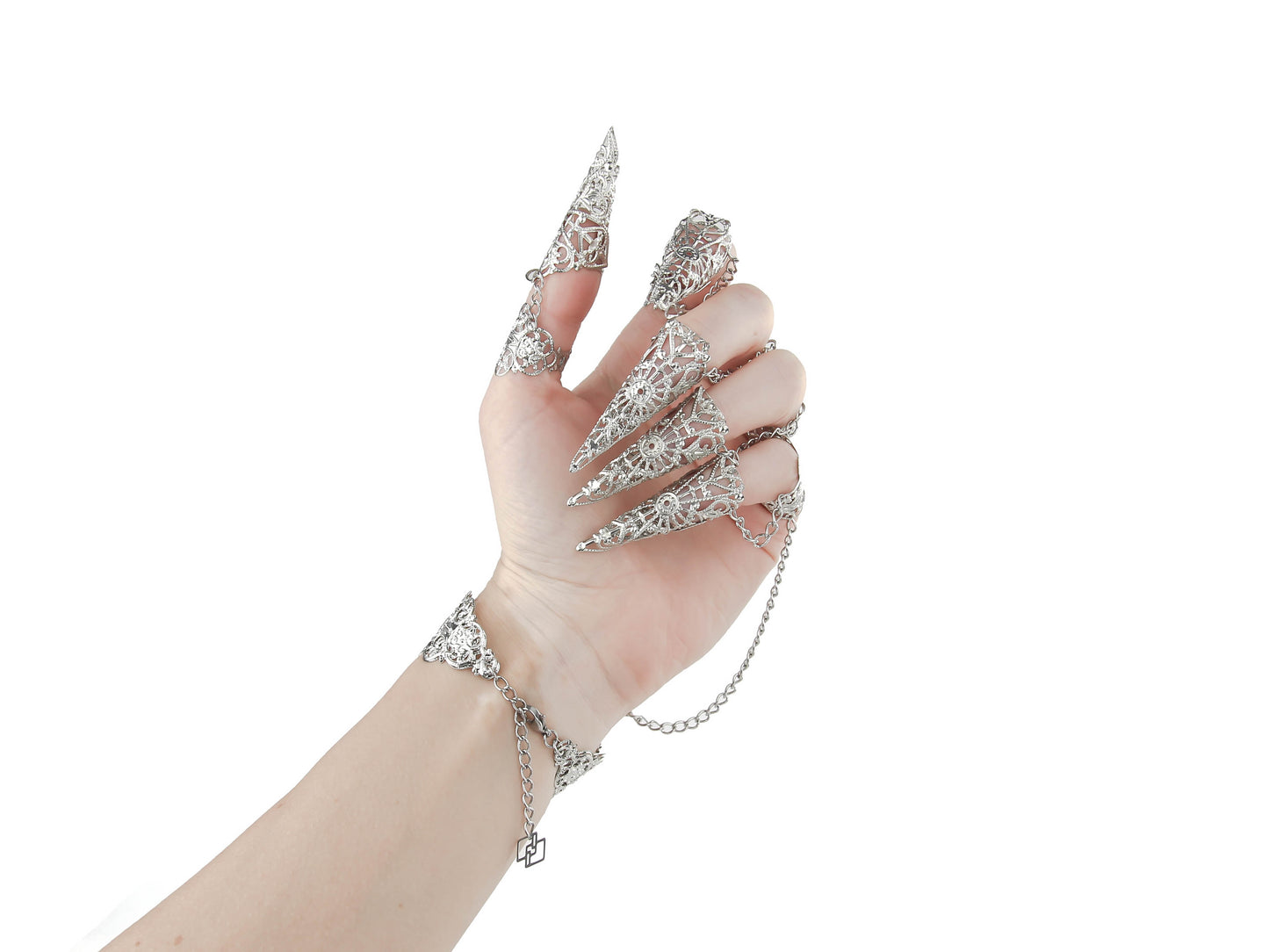 Focus on claw rings of a hand adorned with silver claw rings and chain-linked full finger armor rings, showcasing a dramatic gothic jewelry style, perfect for a dark aesthetic or avant-garde fashion statement