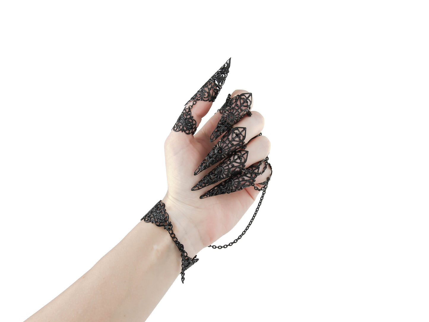 Focus on the claw rings of a hand adorned with black claw rings connected by delicate chains to the bracelt part, showcasing a gothic jewelry style with intricate filigree, perfect for a bold gothic or avant-garde fashion statement.